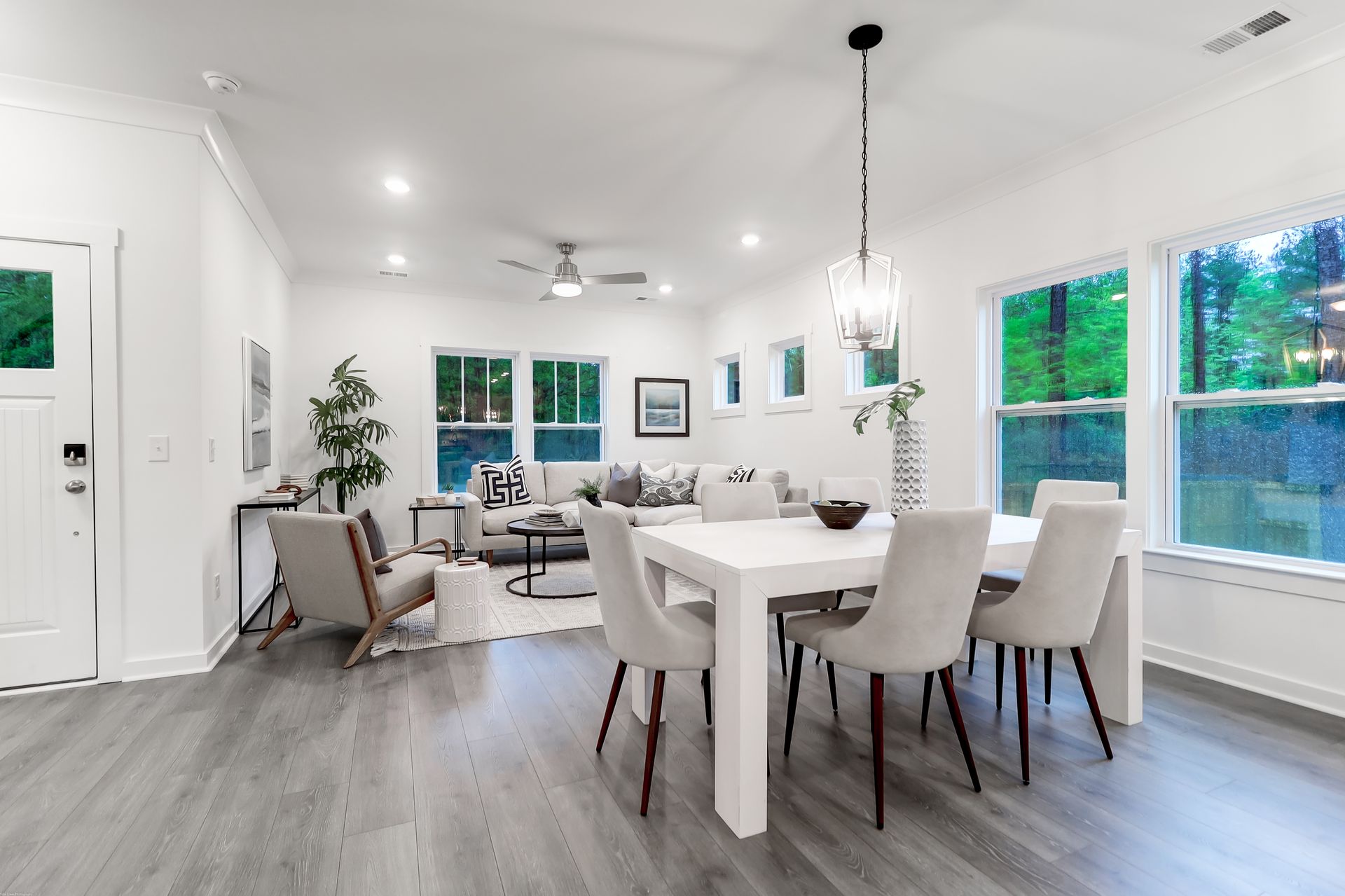 There is a dining table and chairs in the middle of the room.