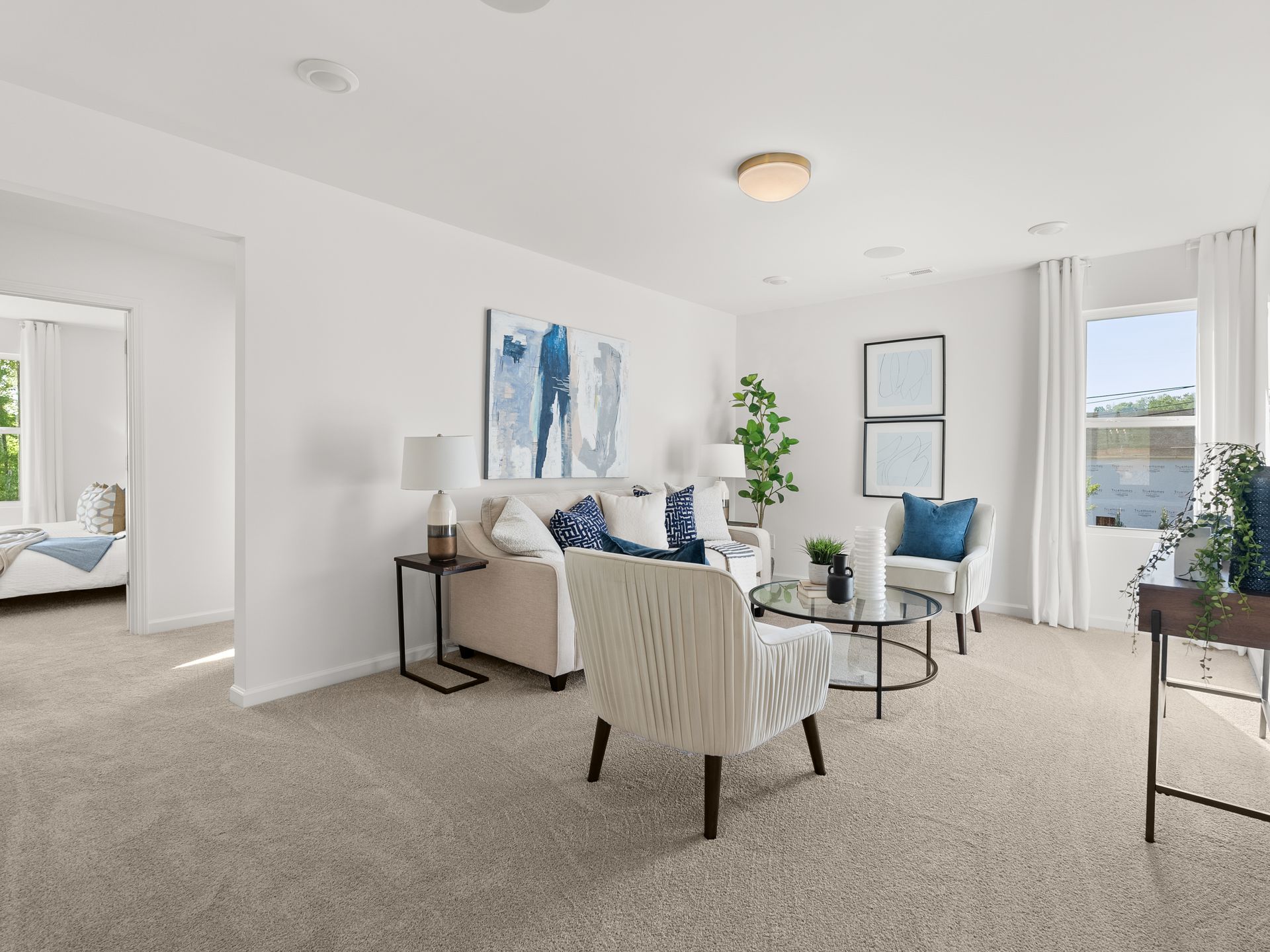 A living room with a couch , chairs , and a table.