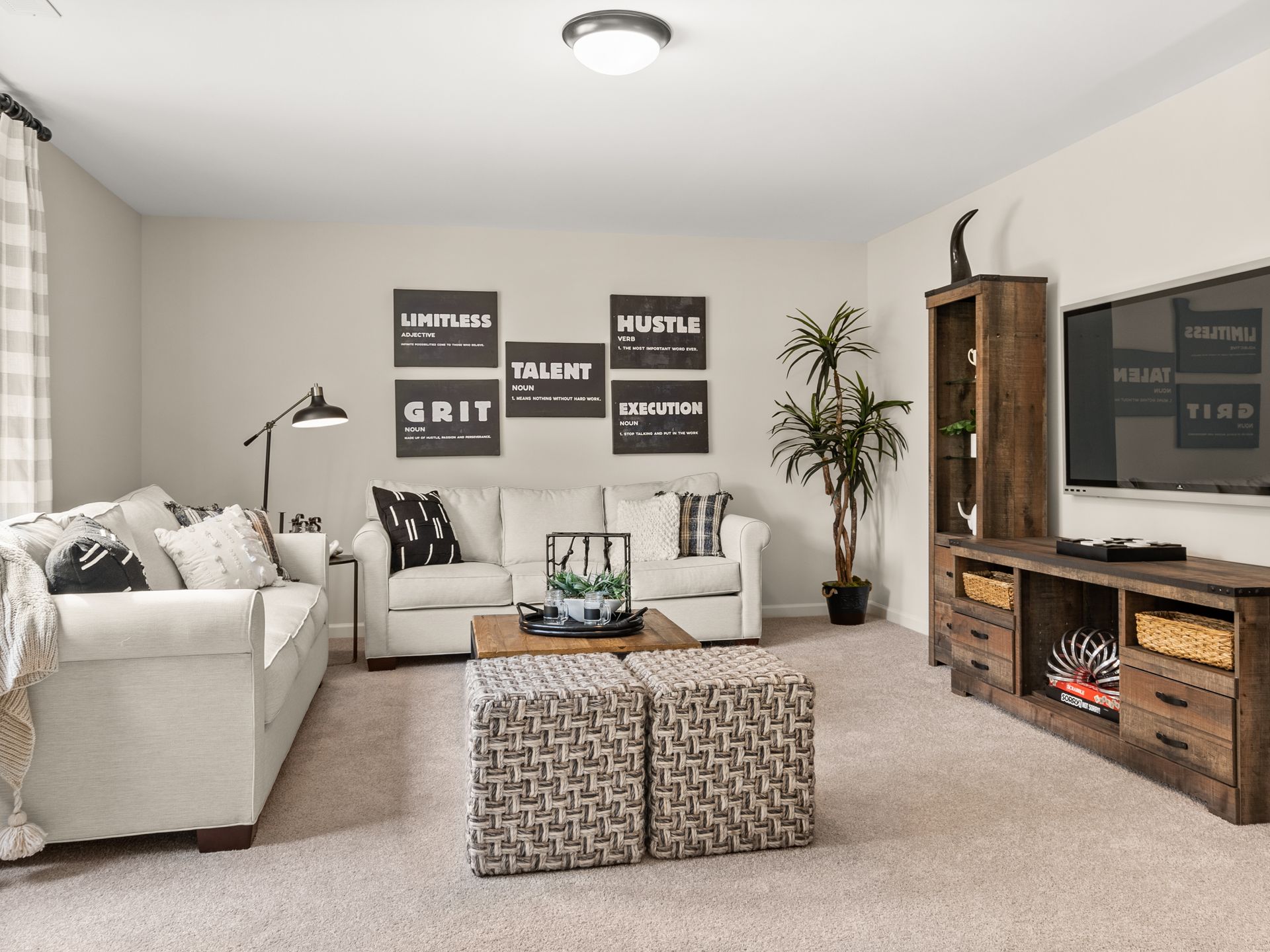 A living room with a couch , coffee table , and television.