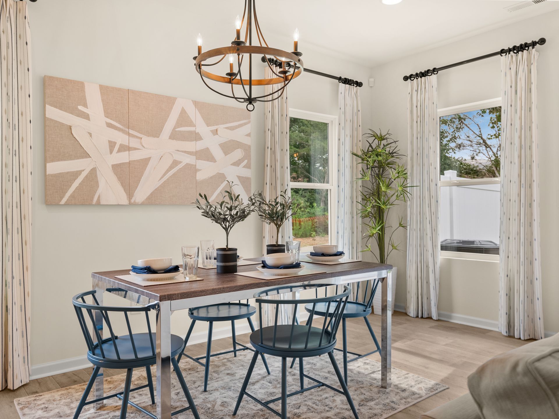 A dining room with a table and chairs and a chandelier.