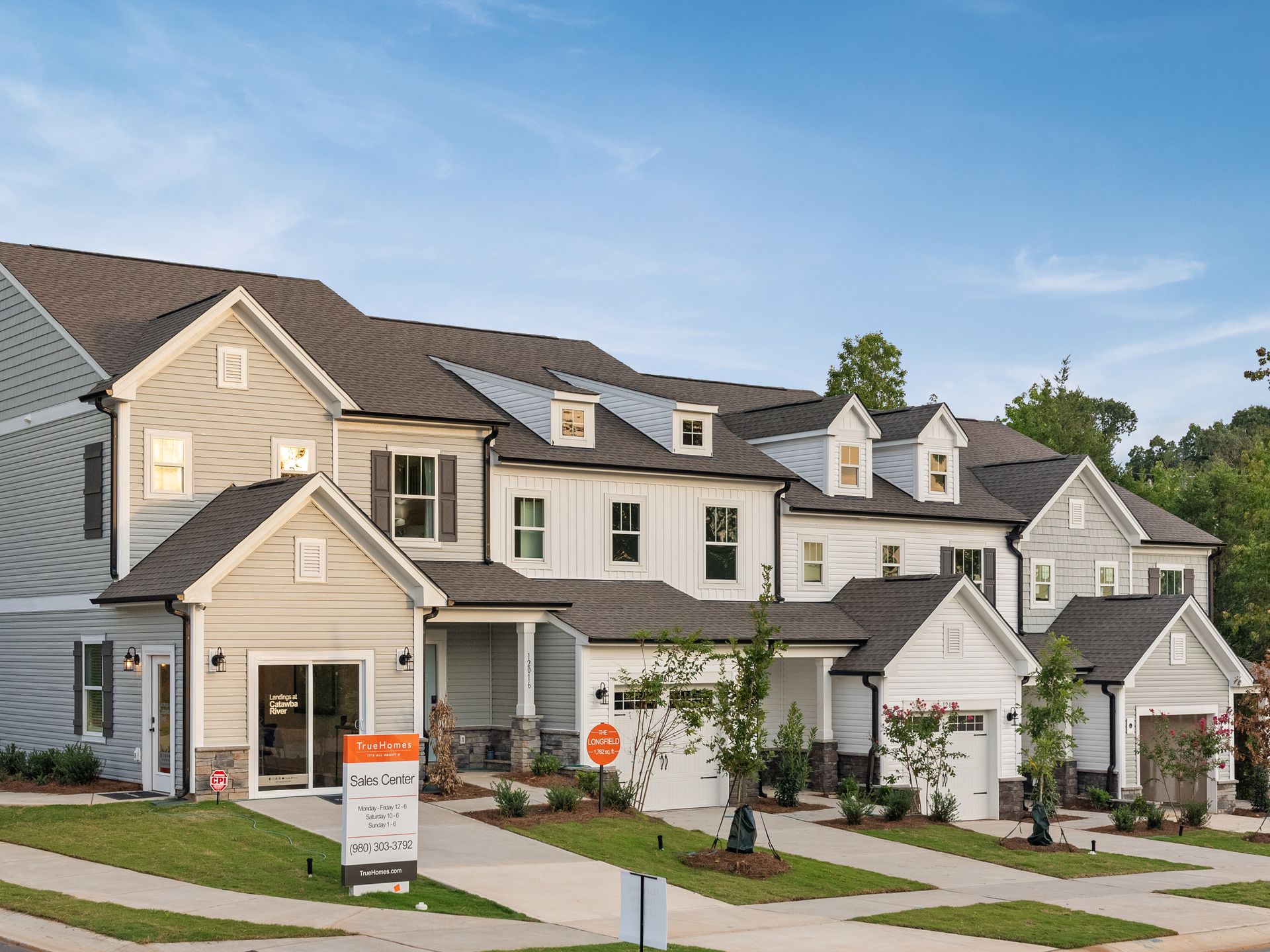 A row of houses are lined up next to each other on a sunny day.