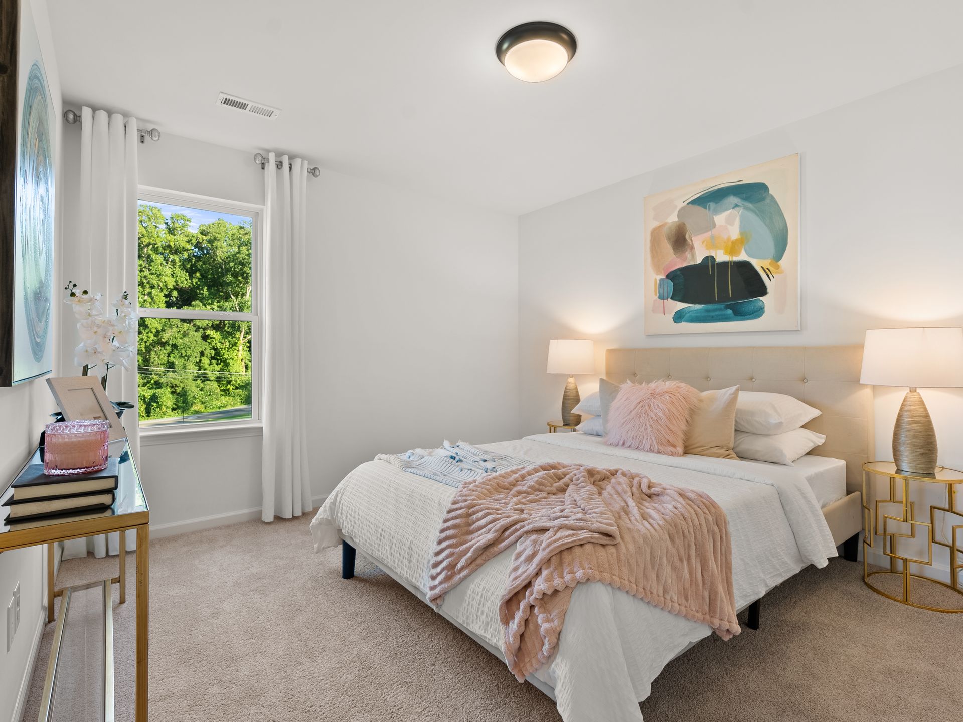 A bedroom with a large bed and a window.