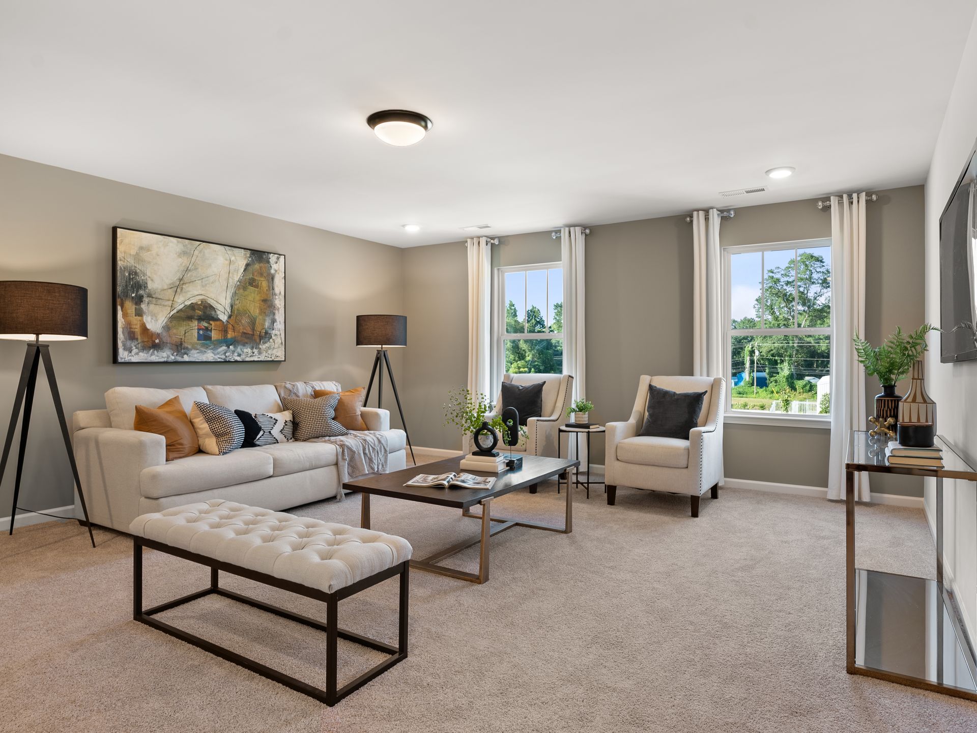 A living room with a couch , chairs , coffee table and television.
