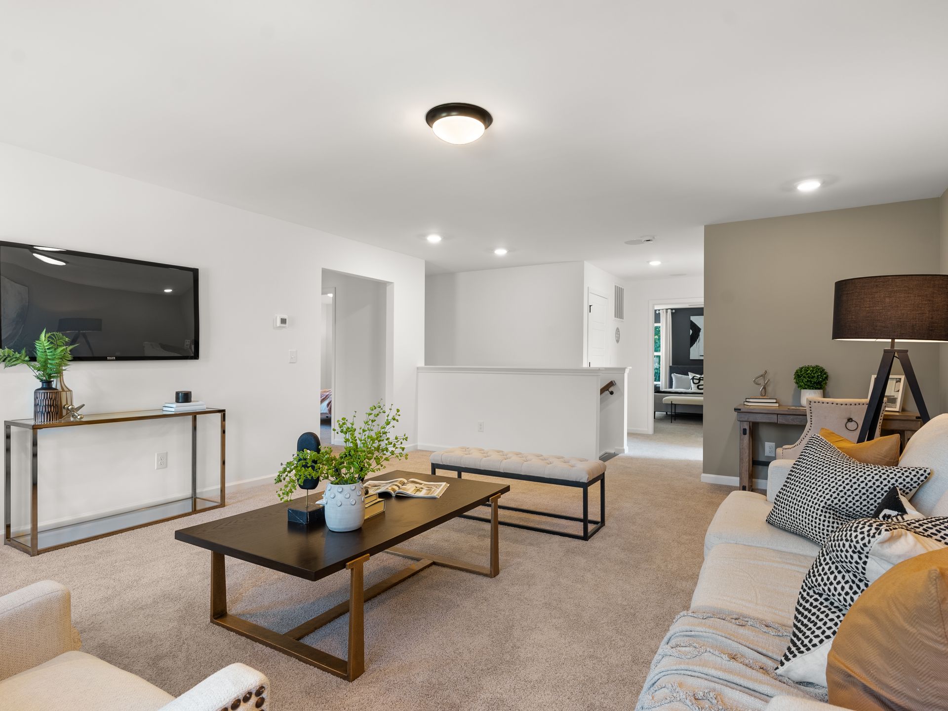 A living room with a couch , chair , coffee table and television.