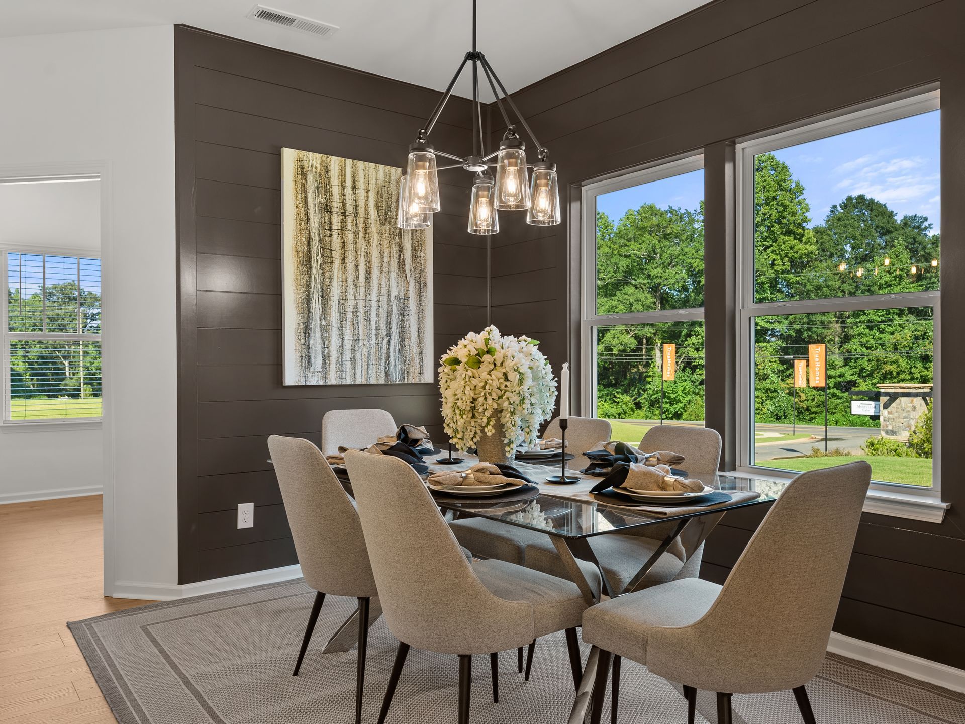 A dining room with a table and chairs and a chandelier.