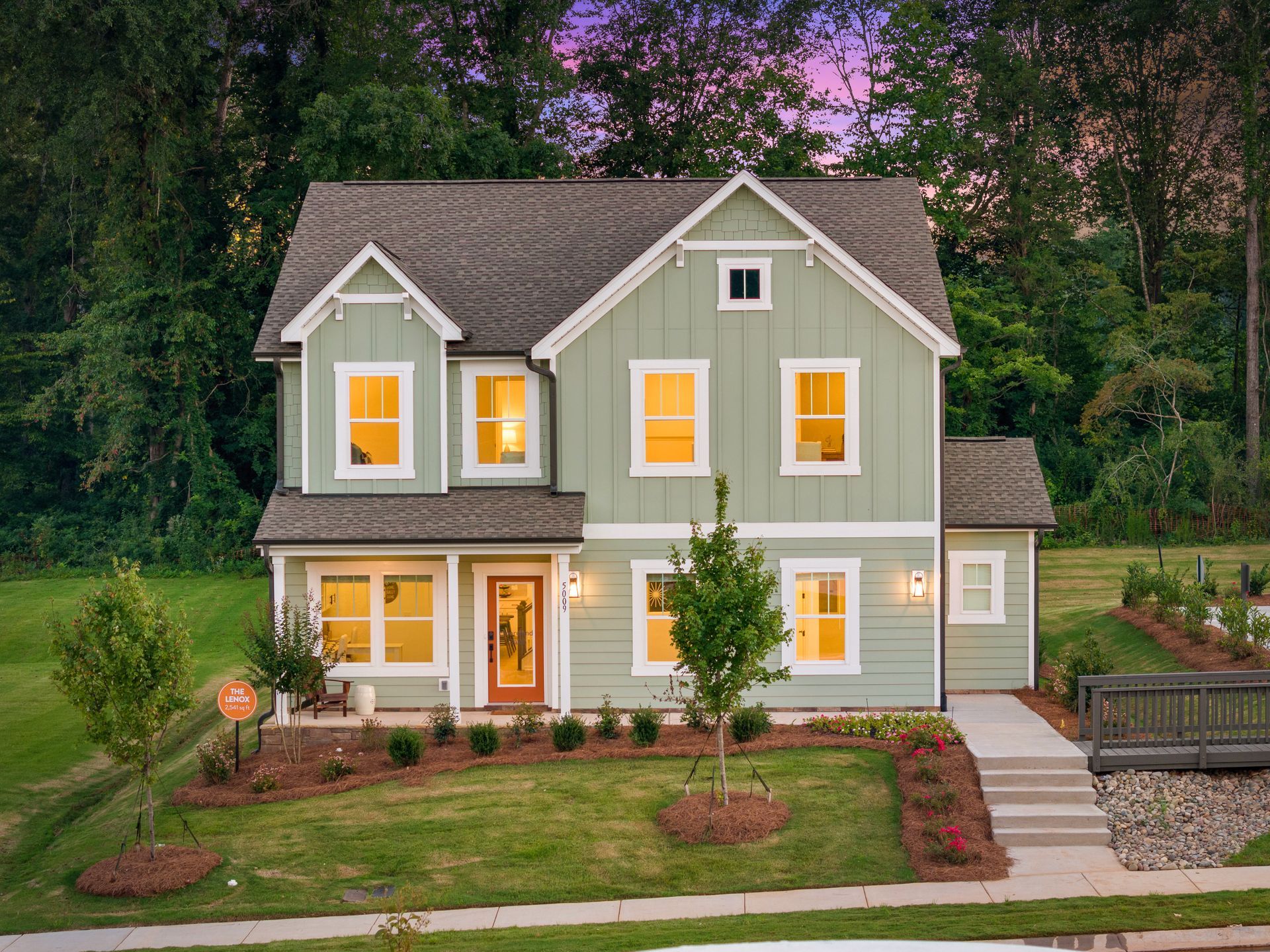 An aerial view of a green house with a lot of windows