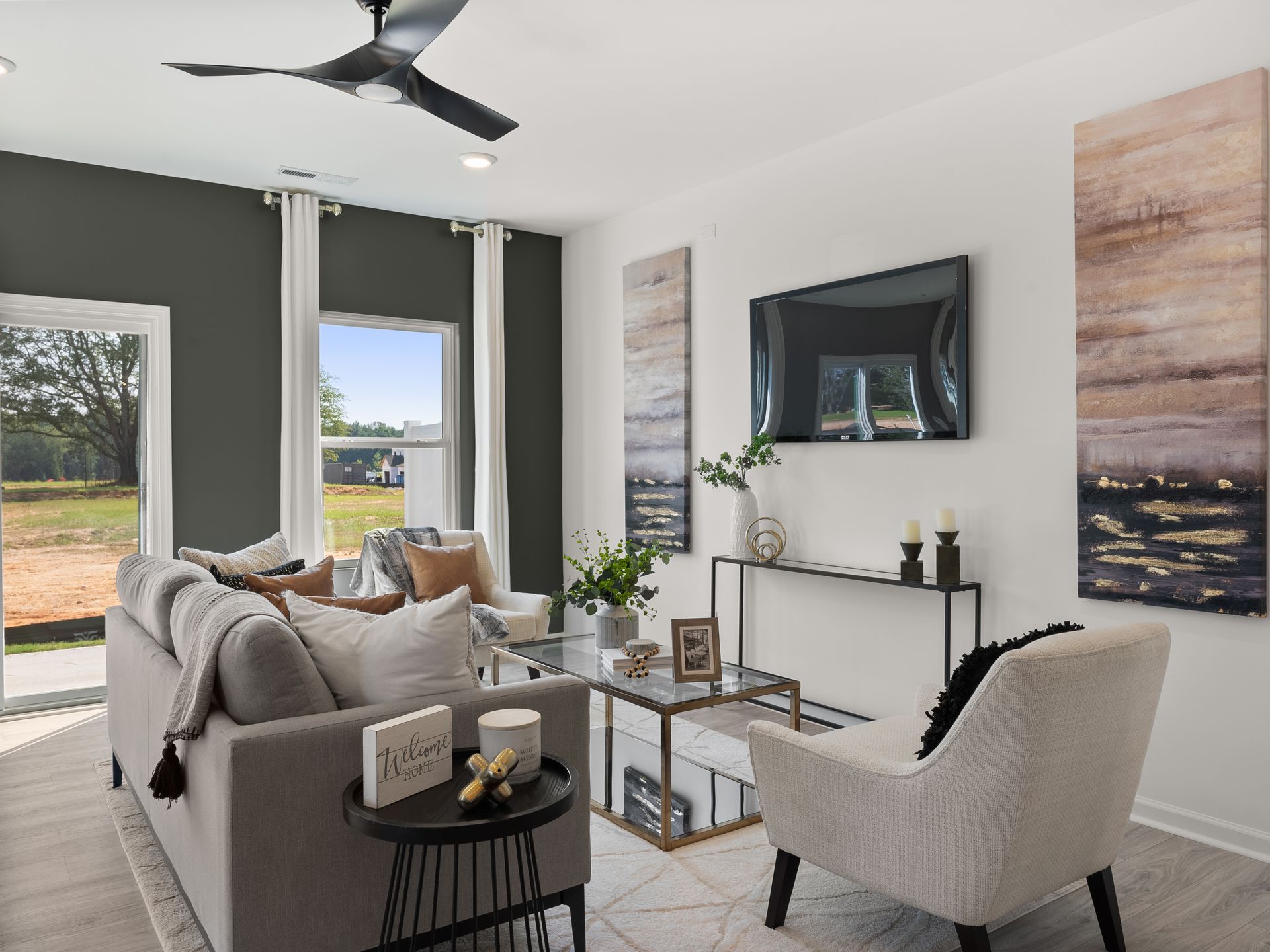 A living room with a couch , chair , table and television.