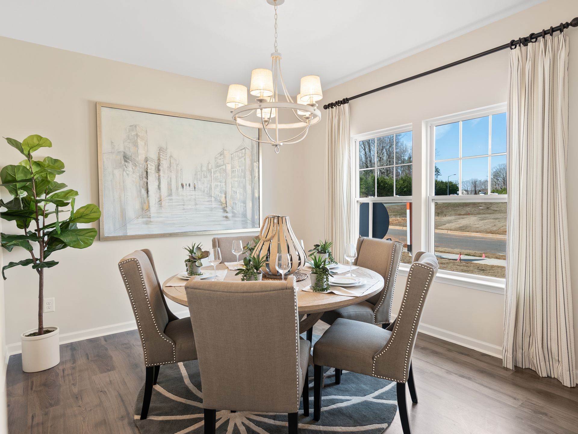 A dining room with a table and chairs and a chandelier.