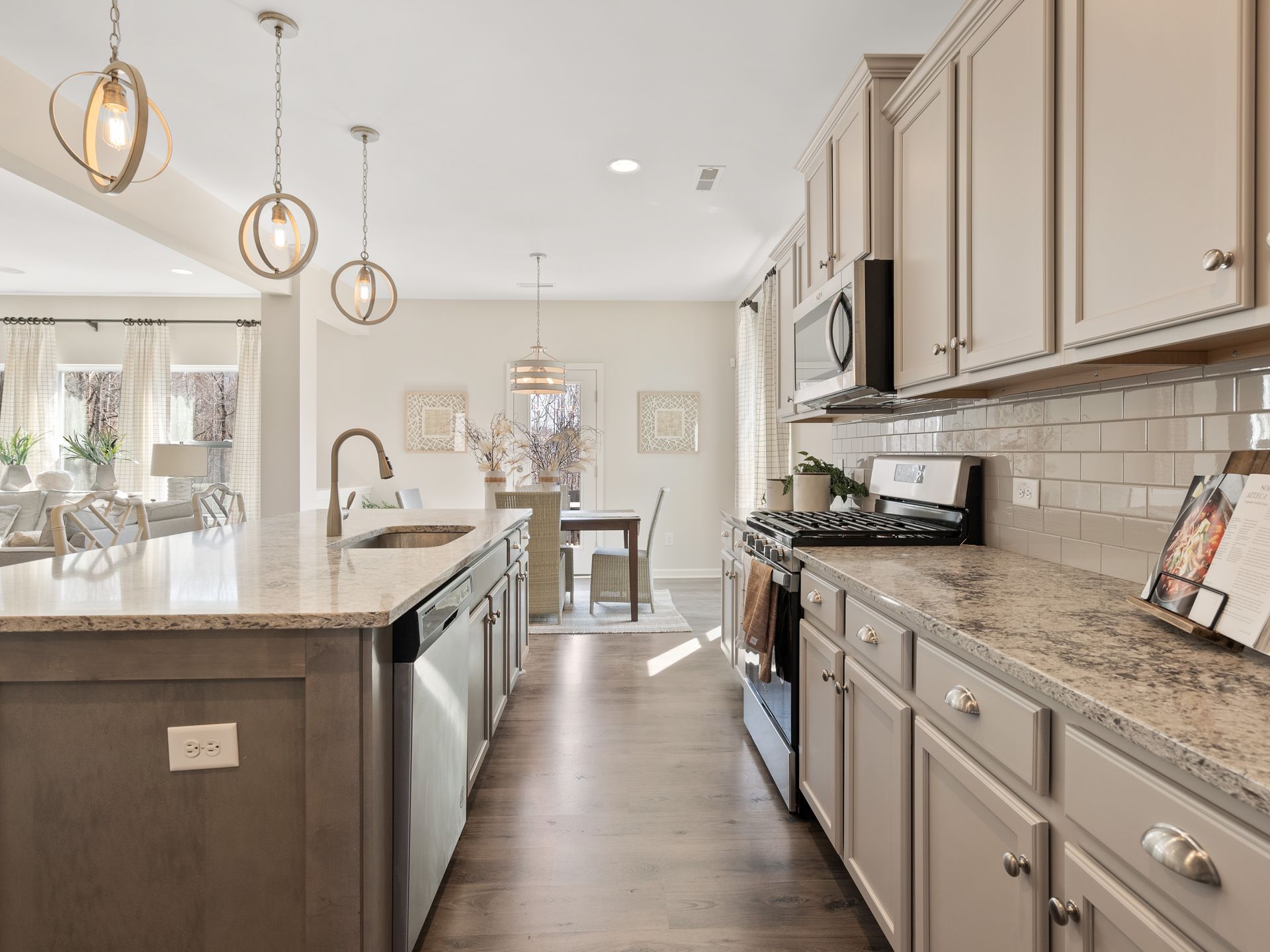 A kitchen with stainless steel appliances and granite counter tops.
