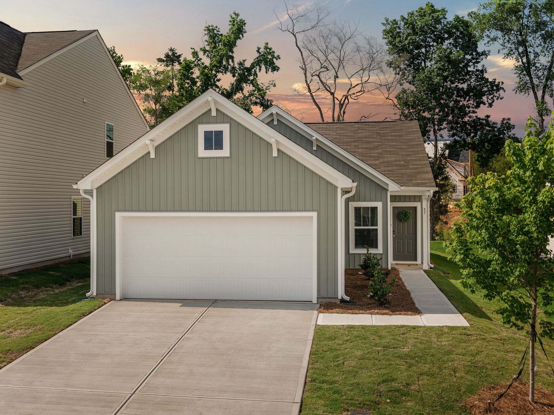 A small house with a garage and a driveway