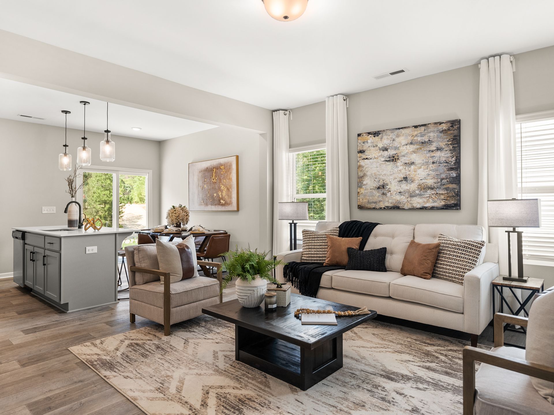 A living room with a couch , chairs , and a coffee table.