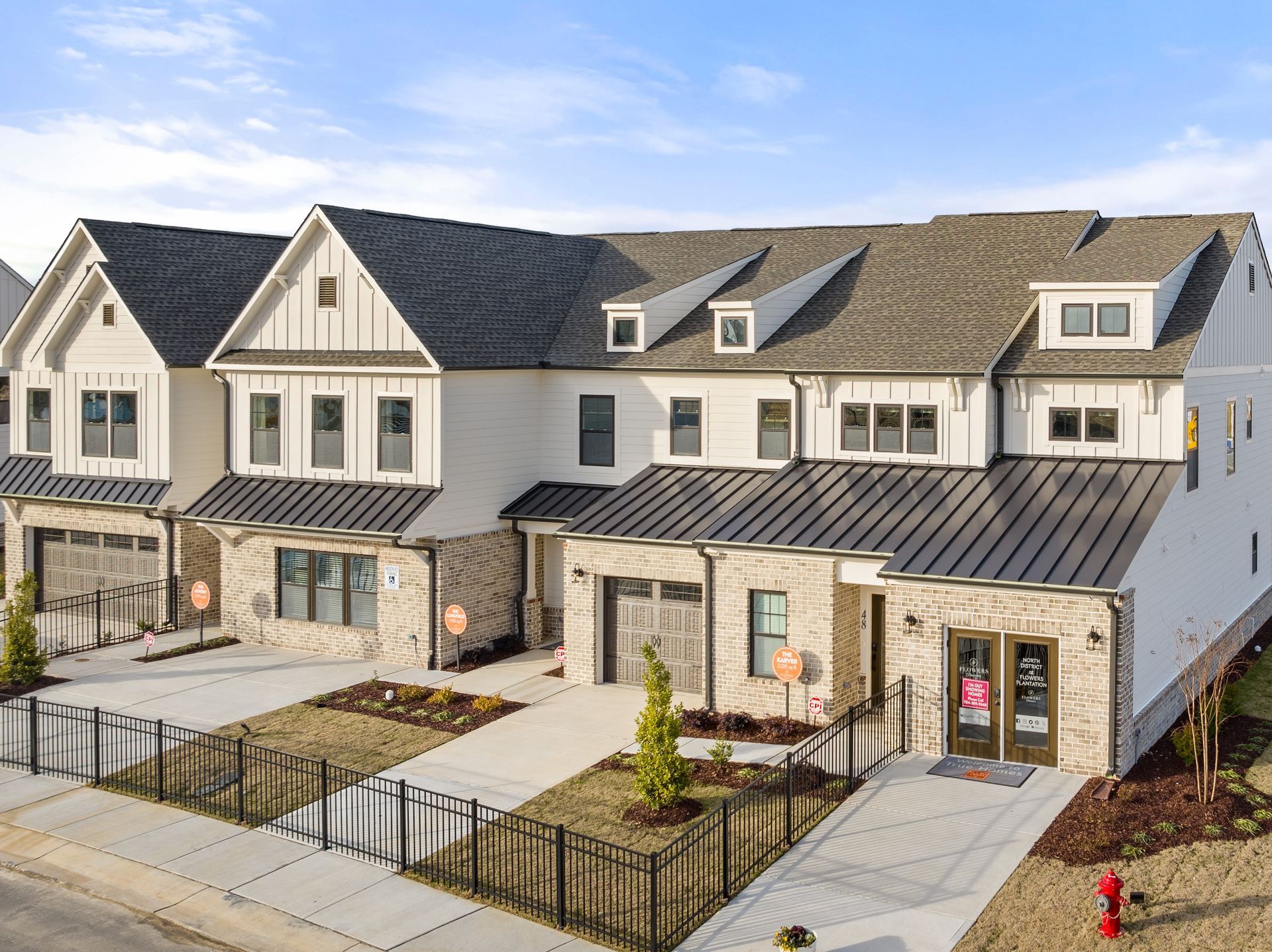 an aerial view of a row of houses with a fire hydrant in front of them .