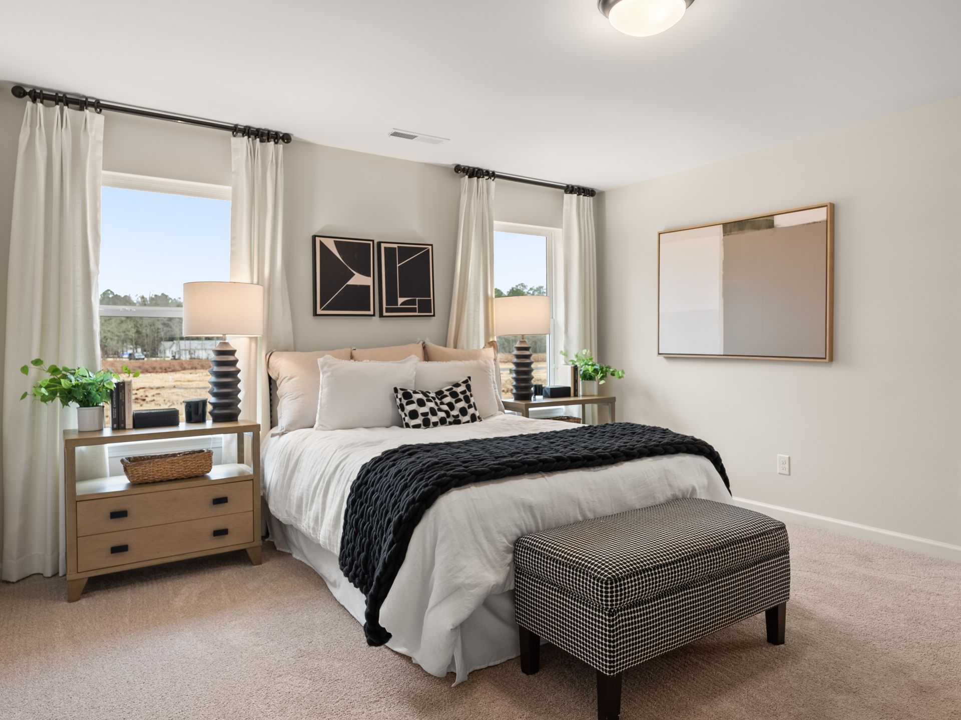 A bedroom with a large bed and a bench