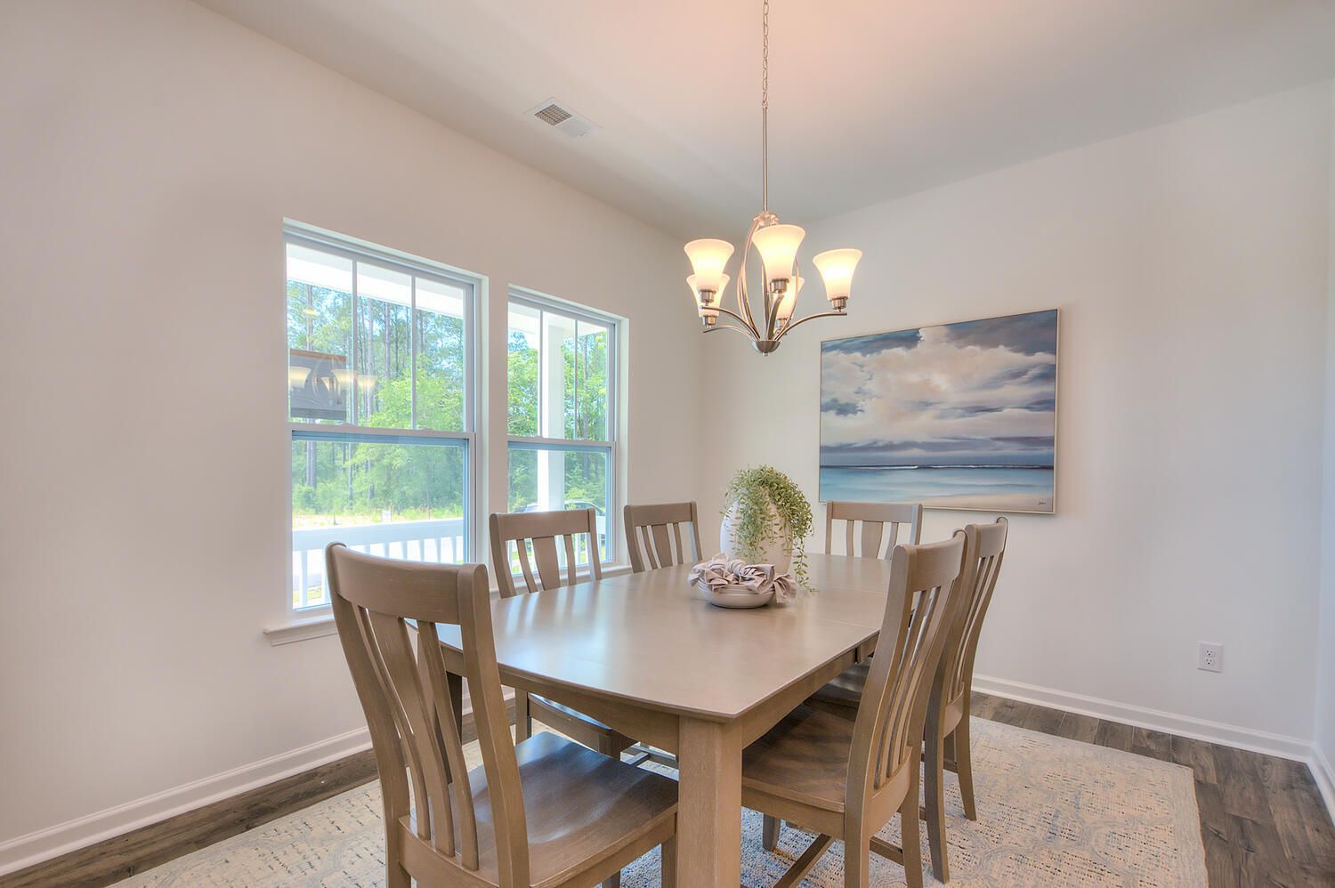A dining room with a table and chairs and a chandelier.