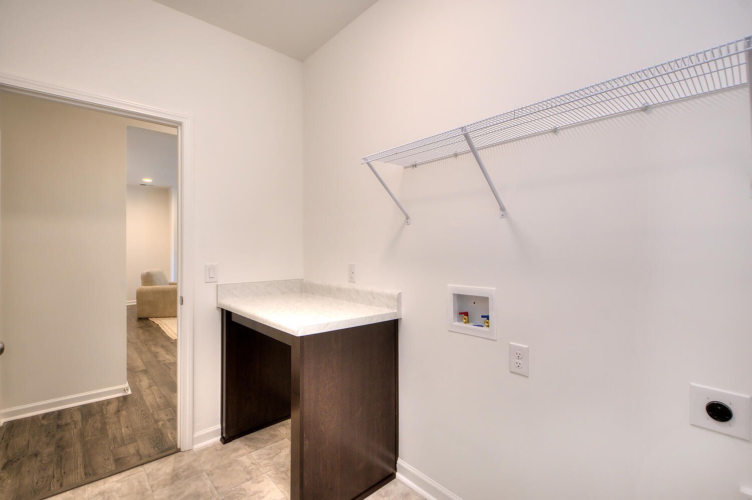 A laundry room in a house with a washer and dryer.