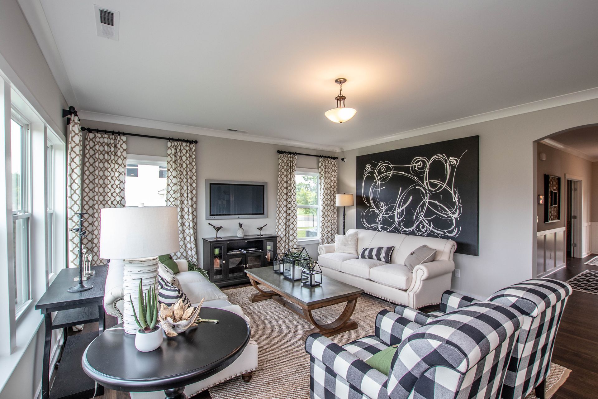 A living room filled with furniture and a television.