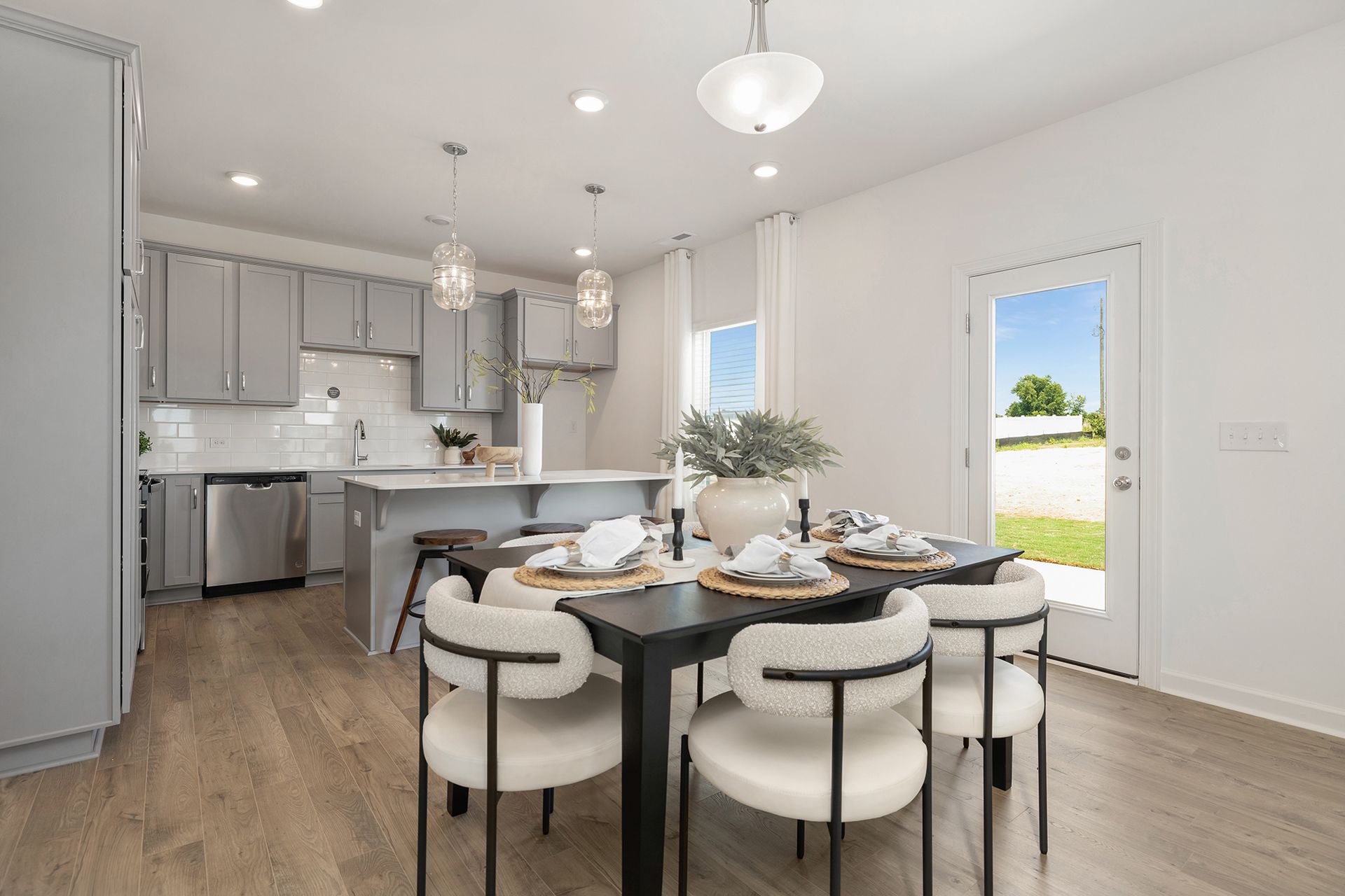 A dining room table and chairs in a model home.