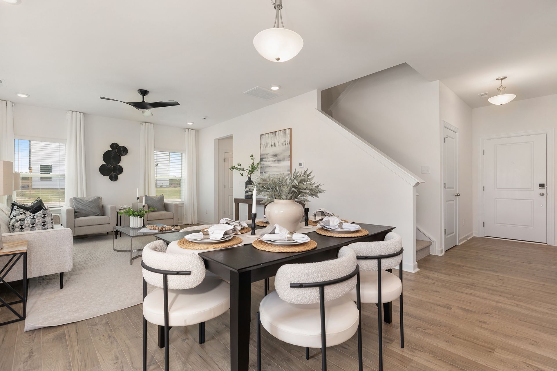 There is a dining table and chairs in the middle of the room.