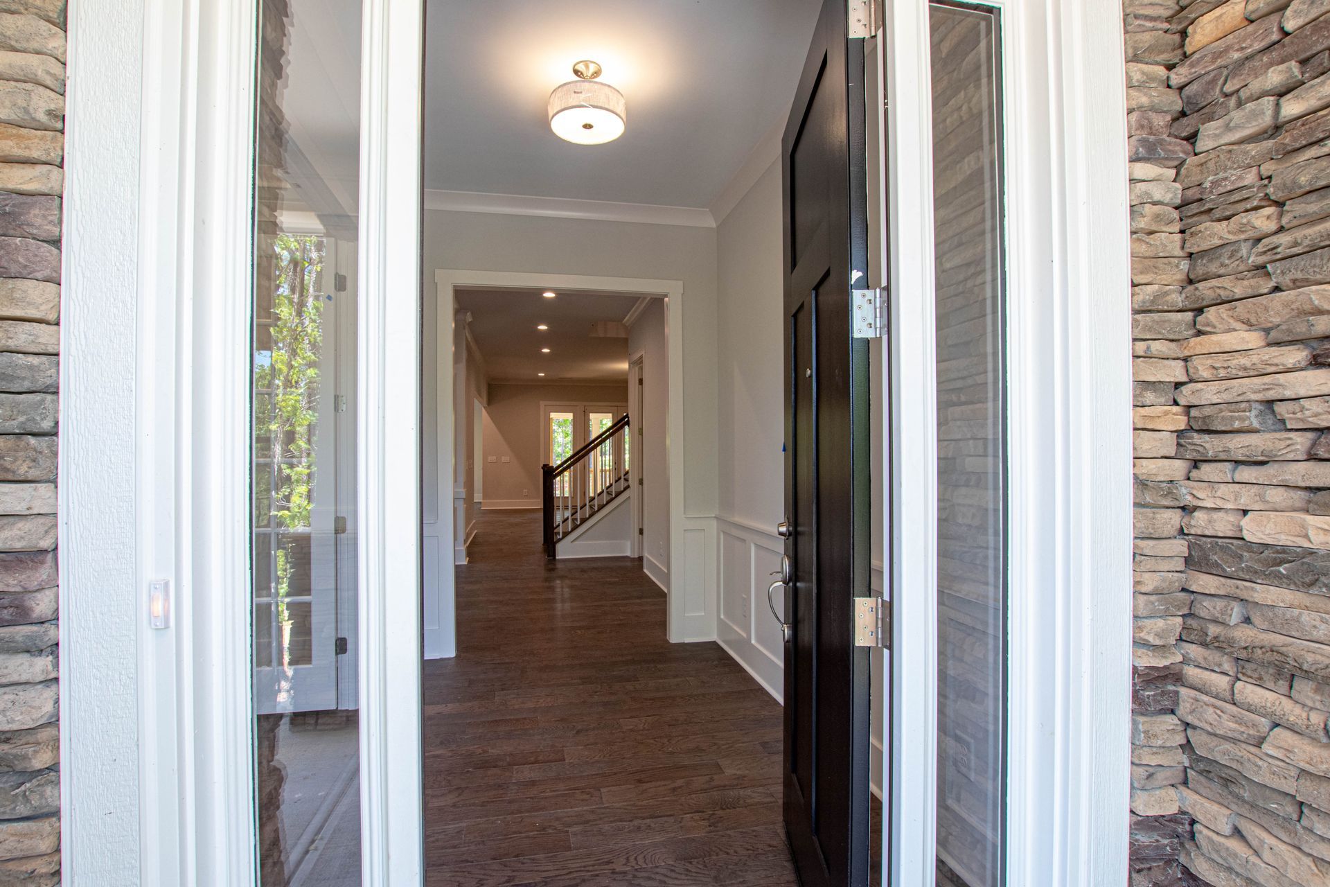 A view of a hallway from the front door of a house.
