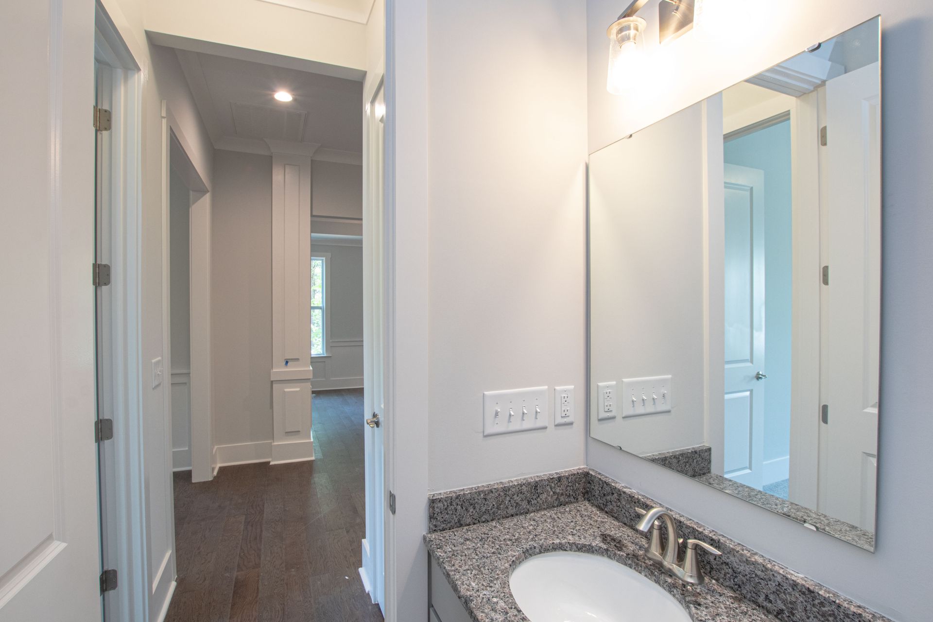 A bathroom with a sink and a large mirror.