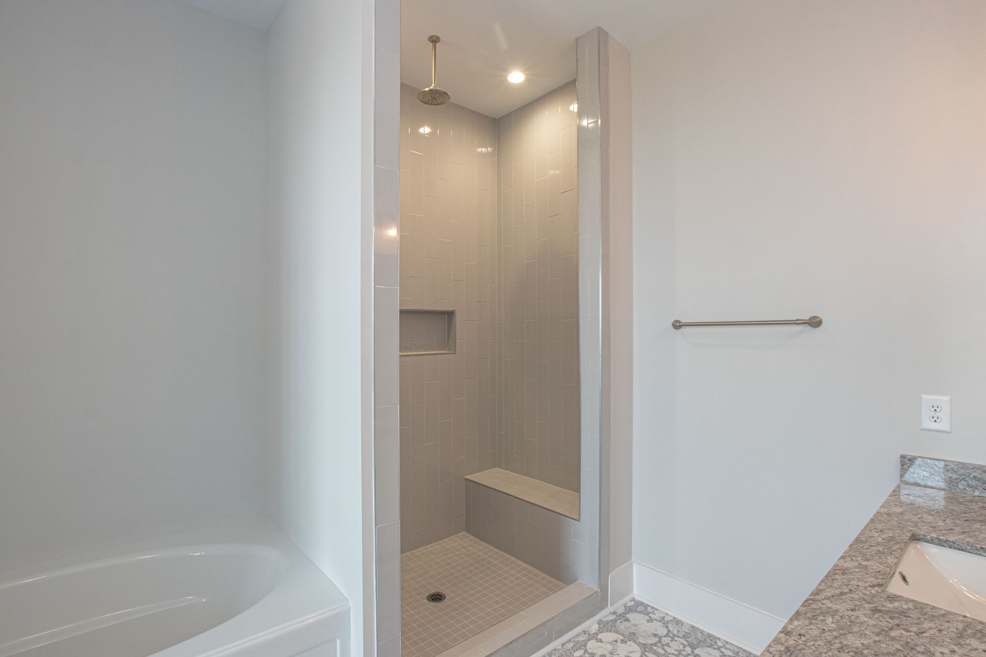 A bathroom with a walk in shower and a bathtub.