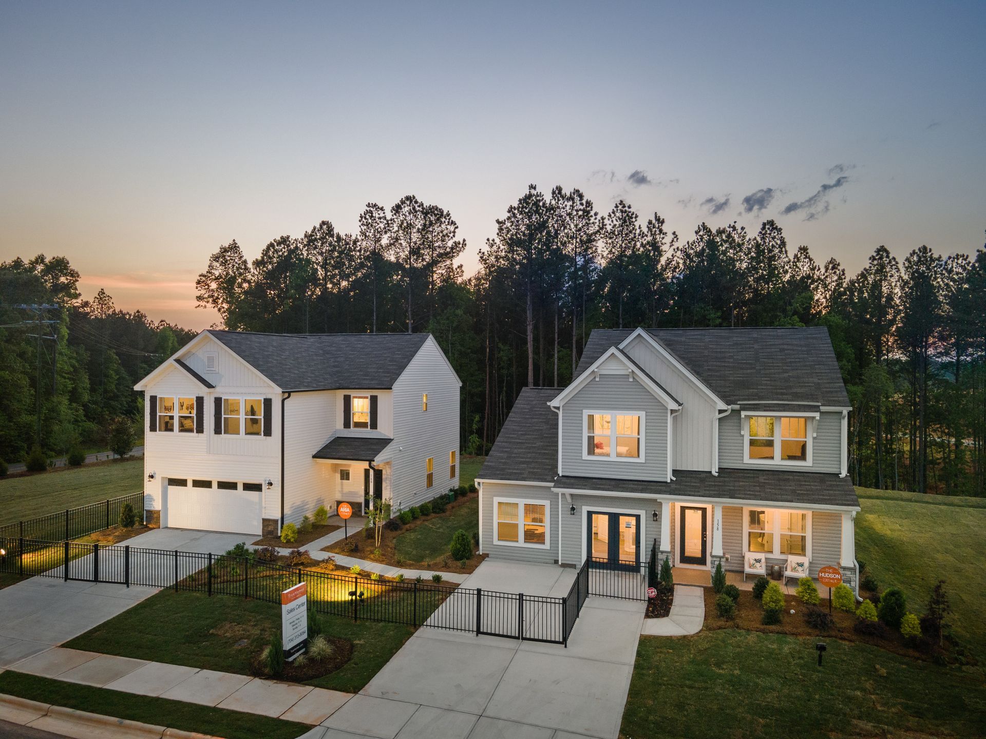 A couple of houses sitting next to each other with trees in the background