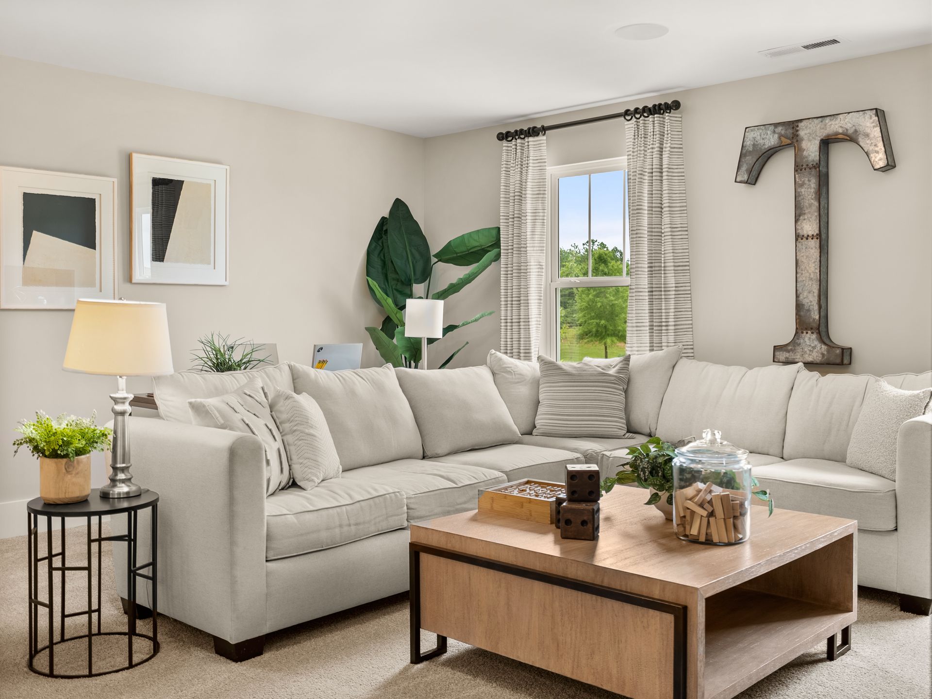 A living room with a large sectional couch and a coffee table.