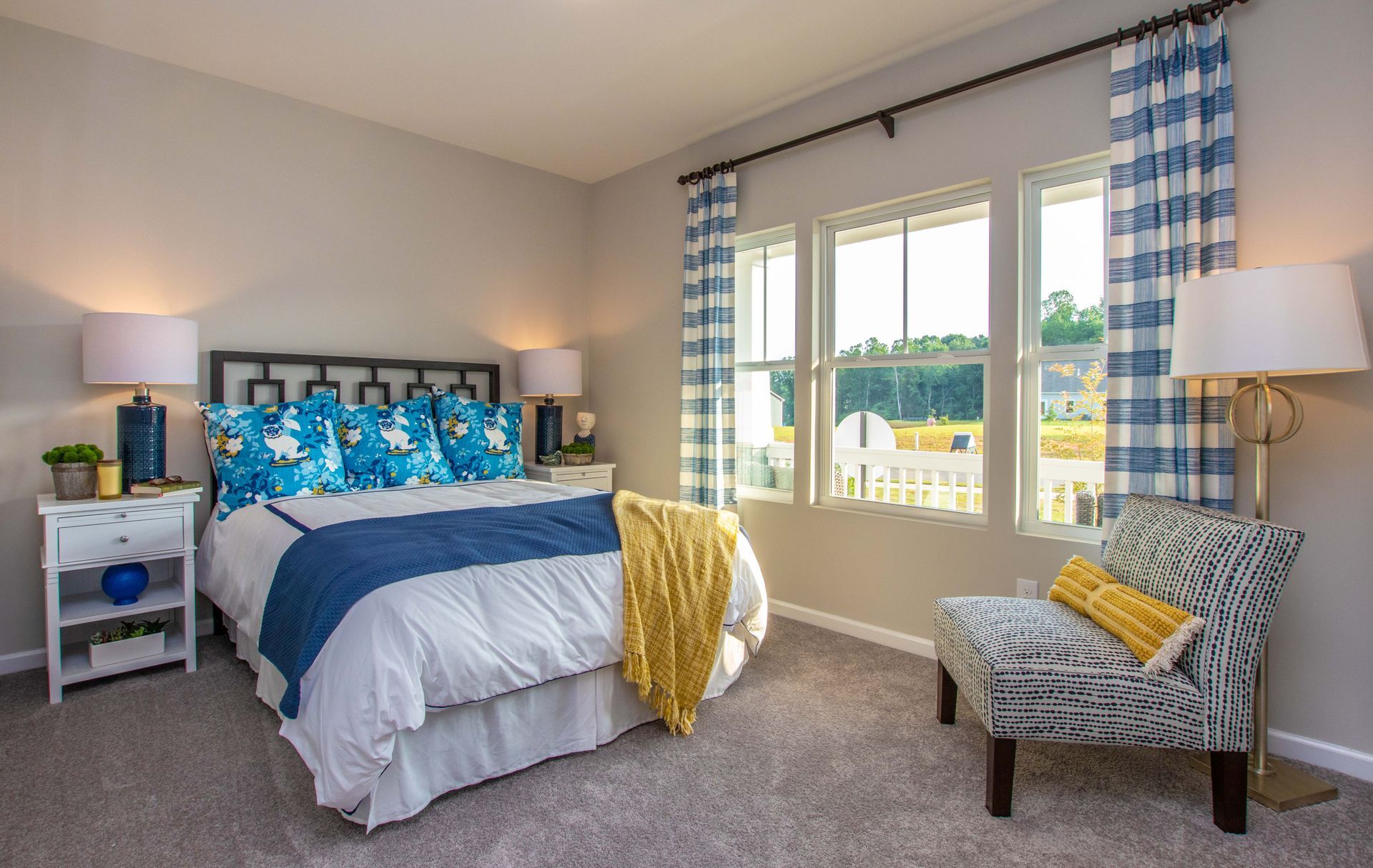 A bedroom with a king size bed and a chair