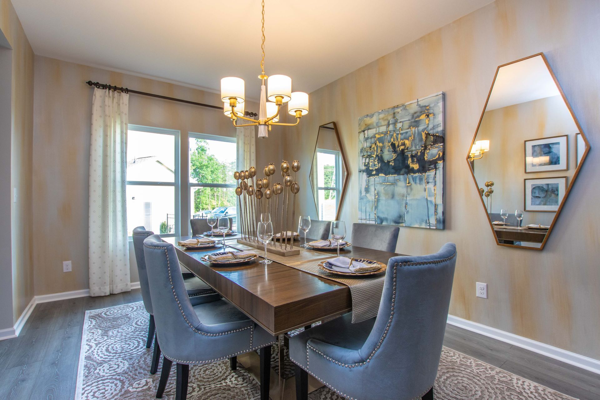 A dining room with a table and chairs and a chandelier.