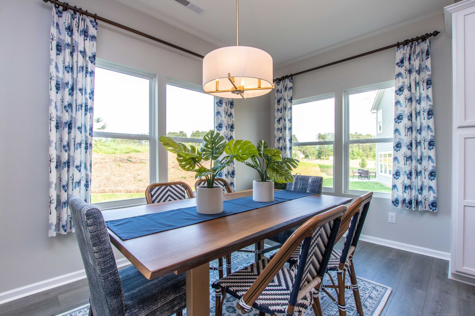 A dining room with a table and chairs and a chandelier.