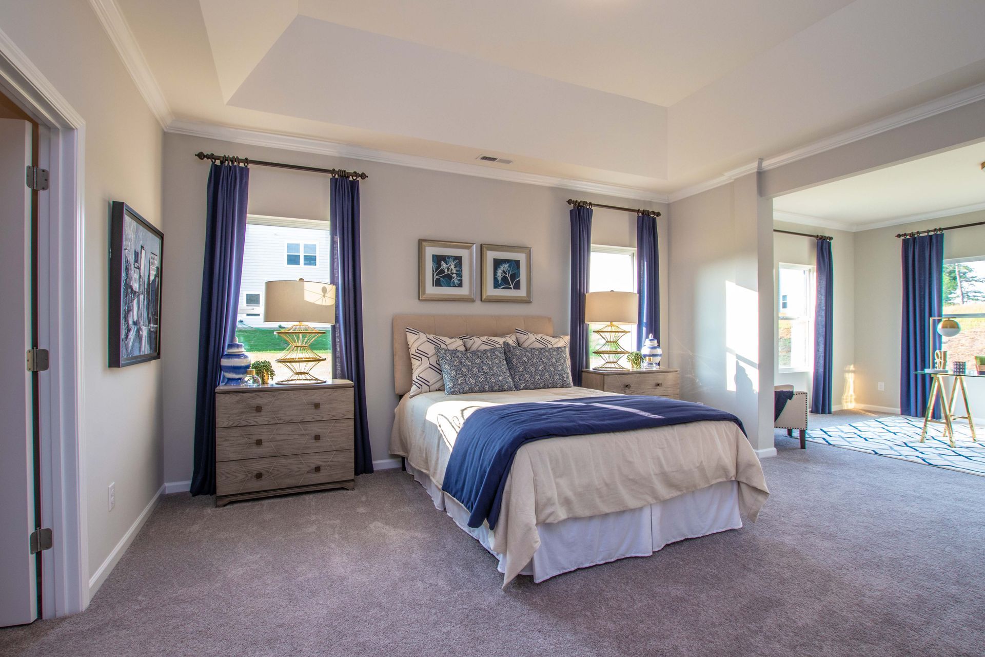 A bedroom with a large bed and a dresser