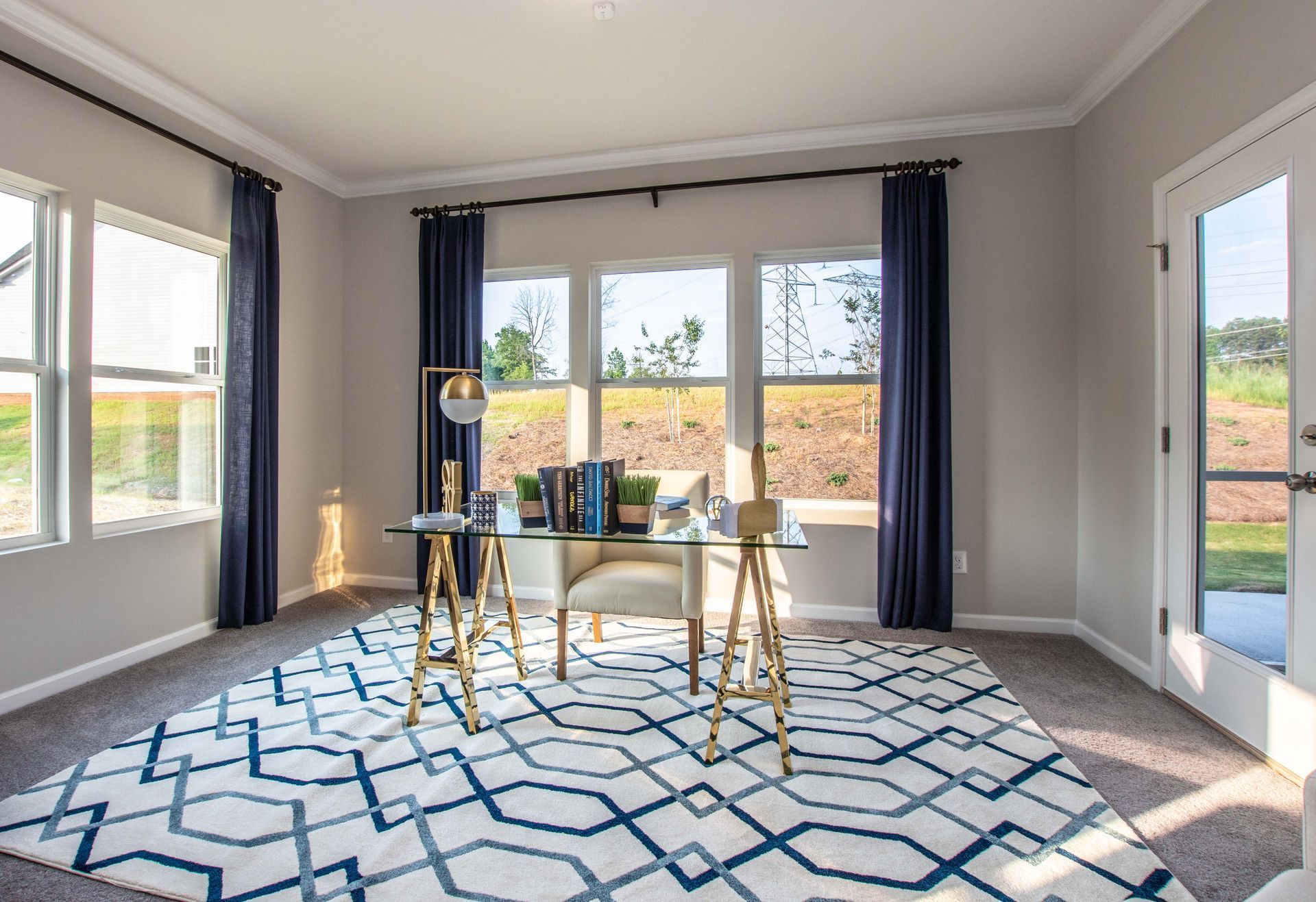 A home office with a desk , chair , and rug.