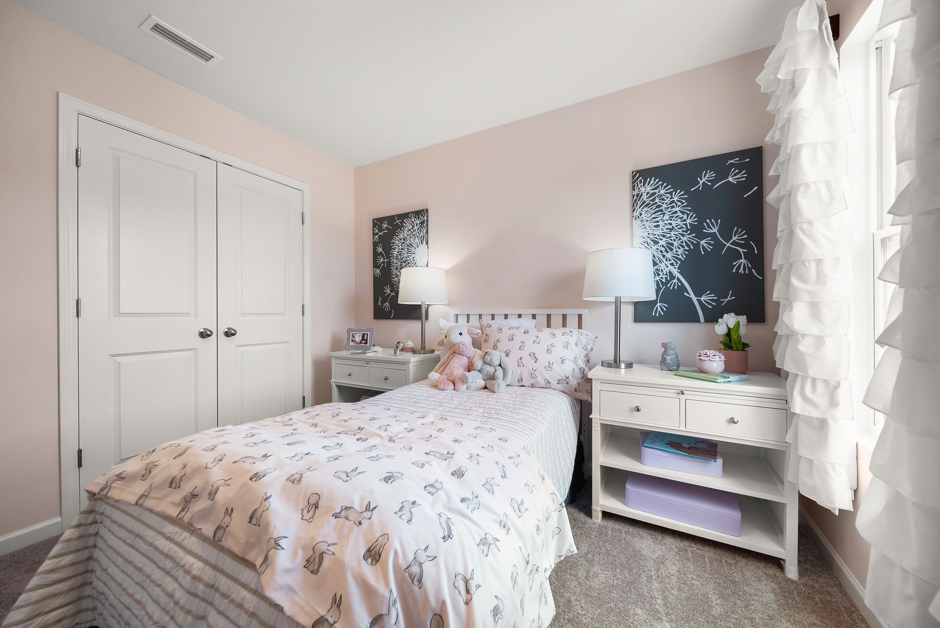 A bedroom with a bed , nightstand , and closet.