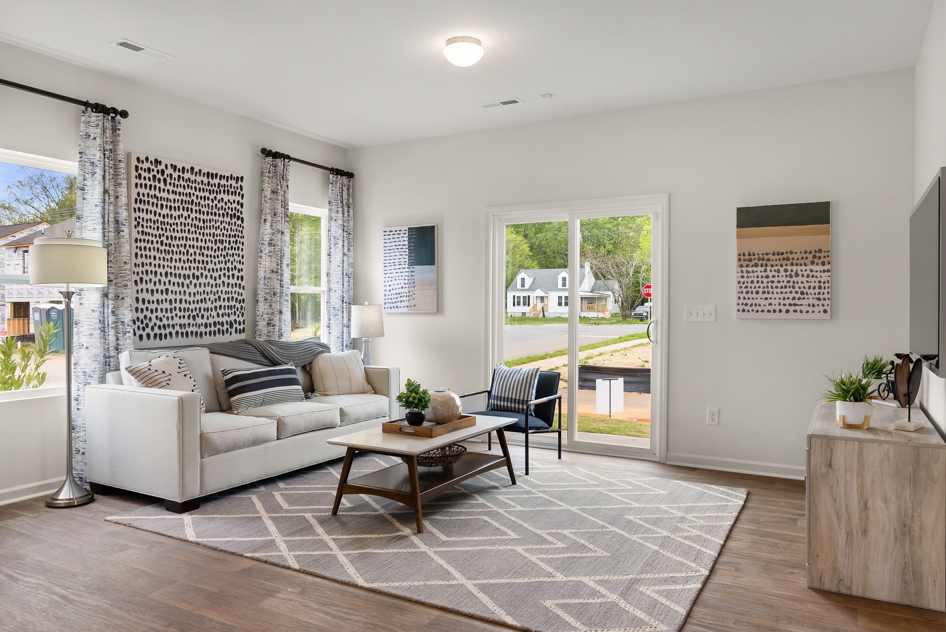 A living room with a couch , coffee table , and sliding glass doors.