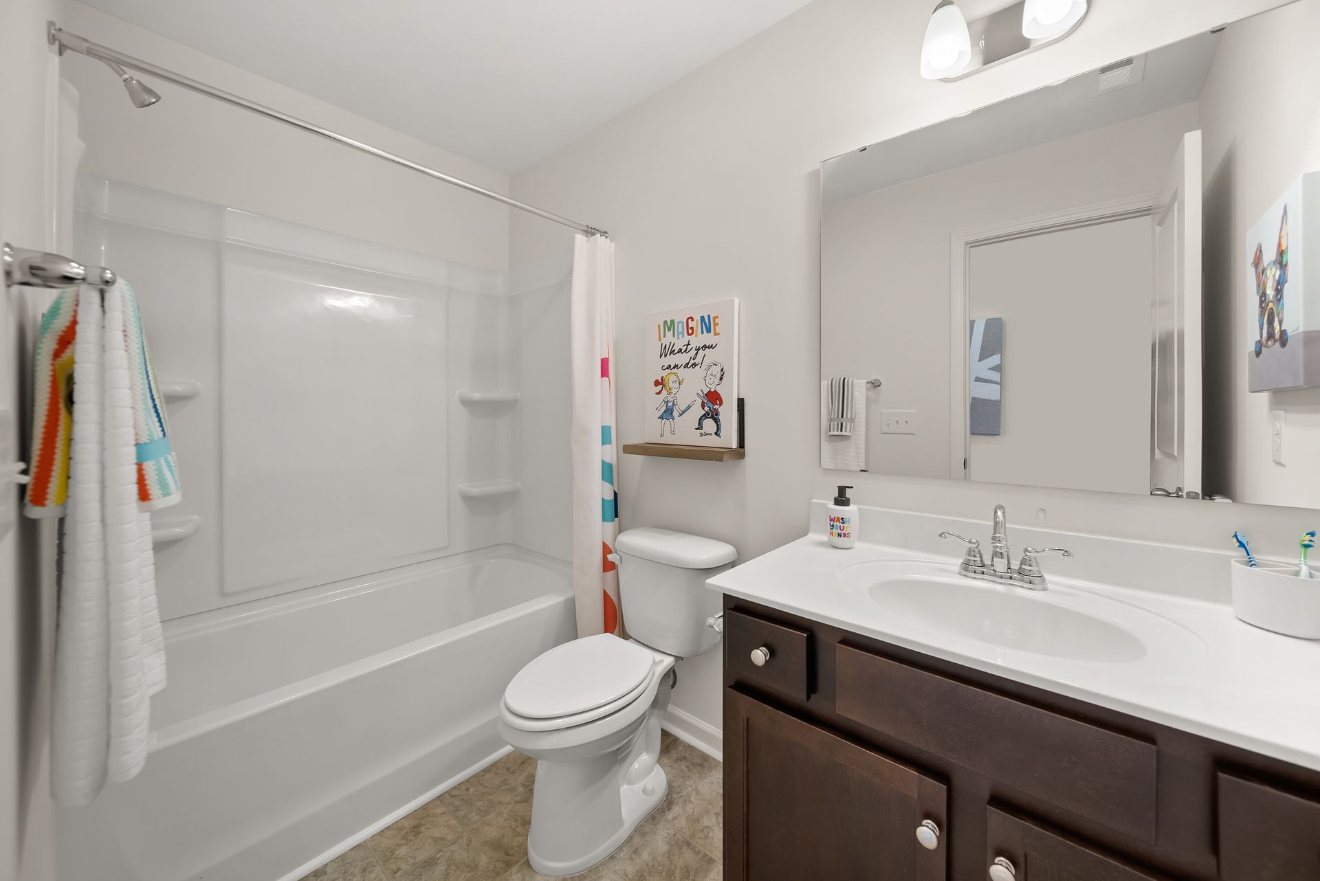 A bathroom with a toilet , sink , and bathtub.