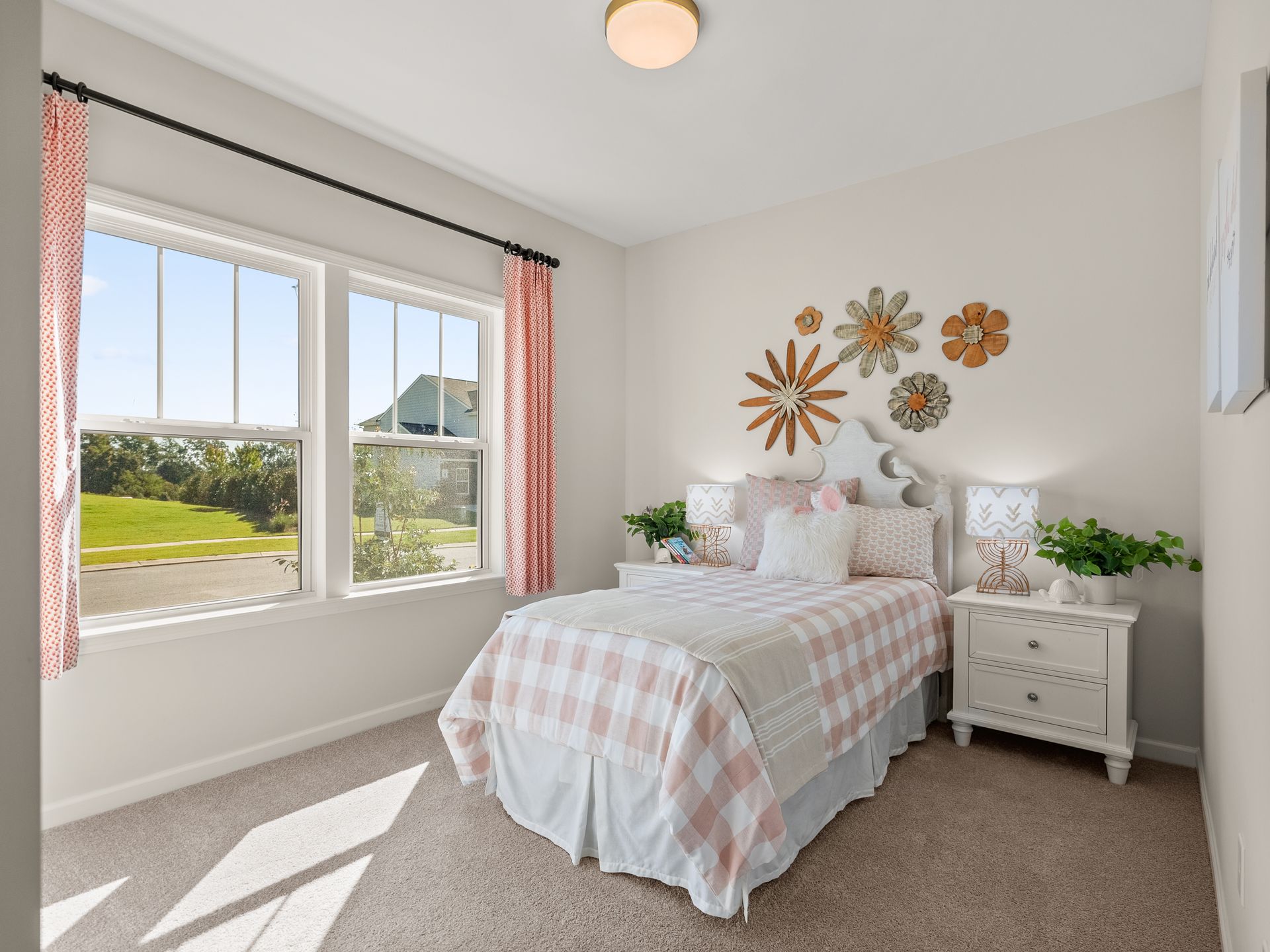 A bedroom with a bed , nightstand , and two windows.