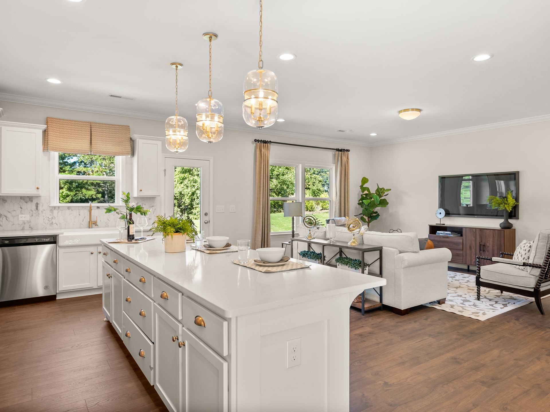 A kitchen with a large island in the middle of it and a living room.