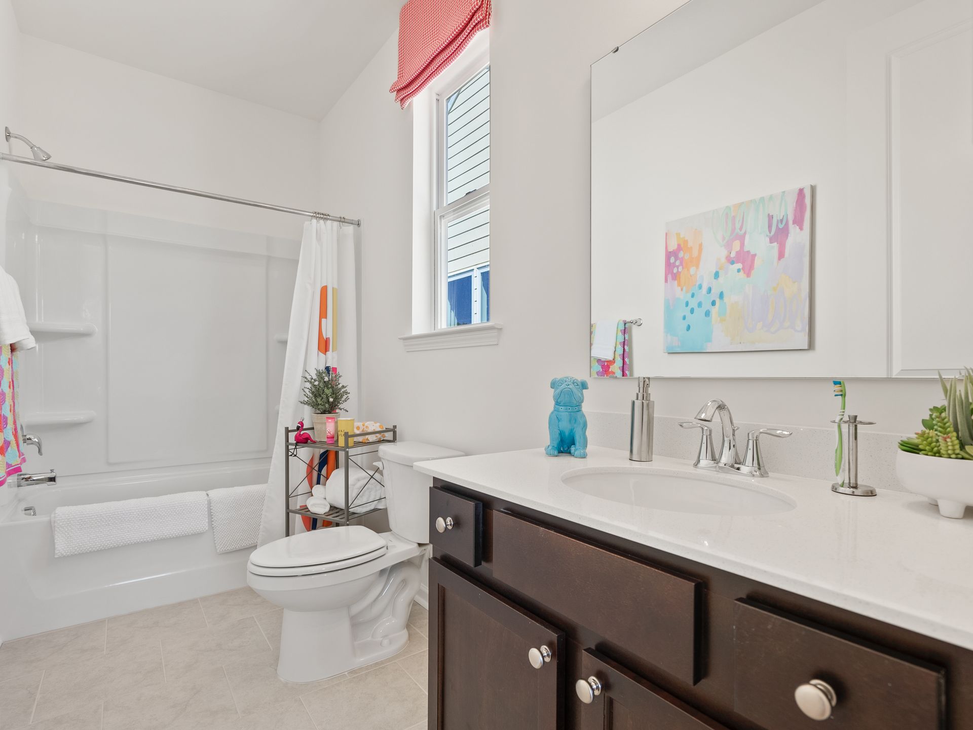 A bathroom with a toilet , sink , and bathtub.