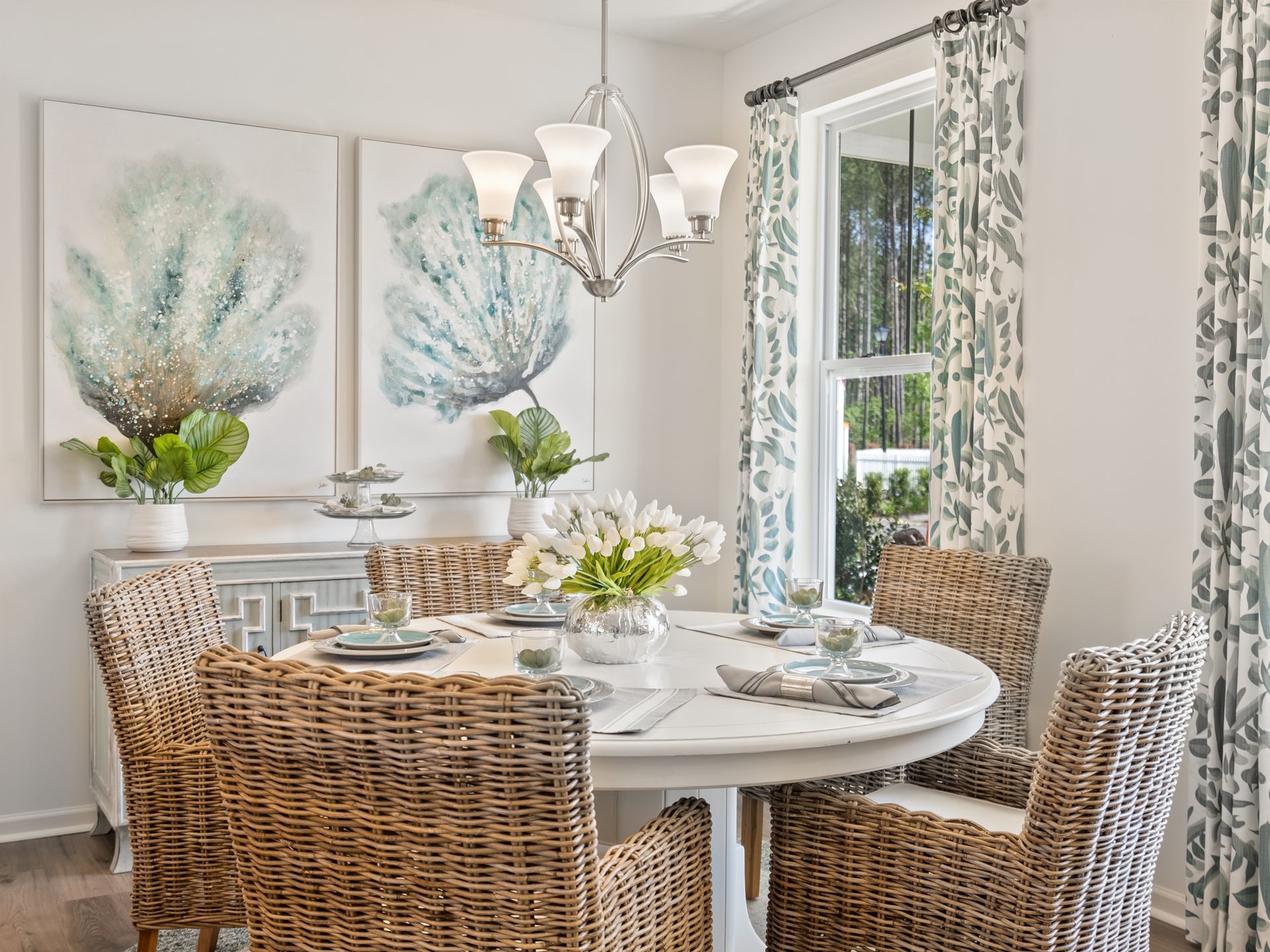 A dining room with a table and chairs and a chandelier.
