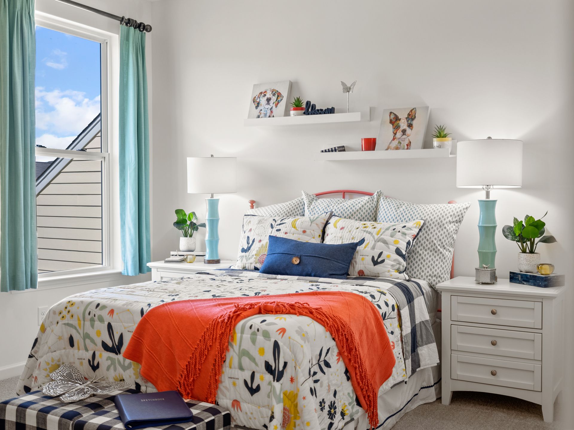 A bedroom with a bed , nightstand , lamps and a window.