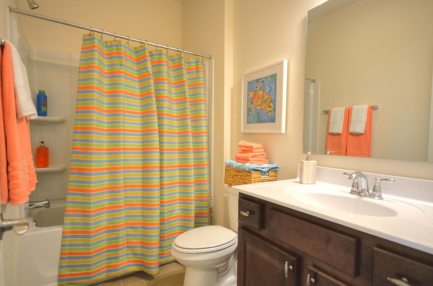 A bathroom with a toilet , sink , and shower curtain.