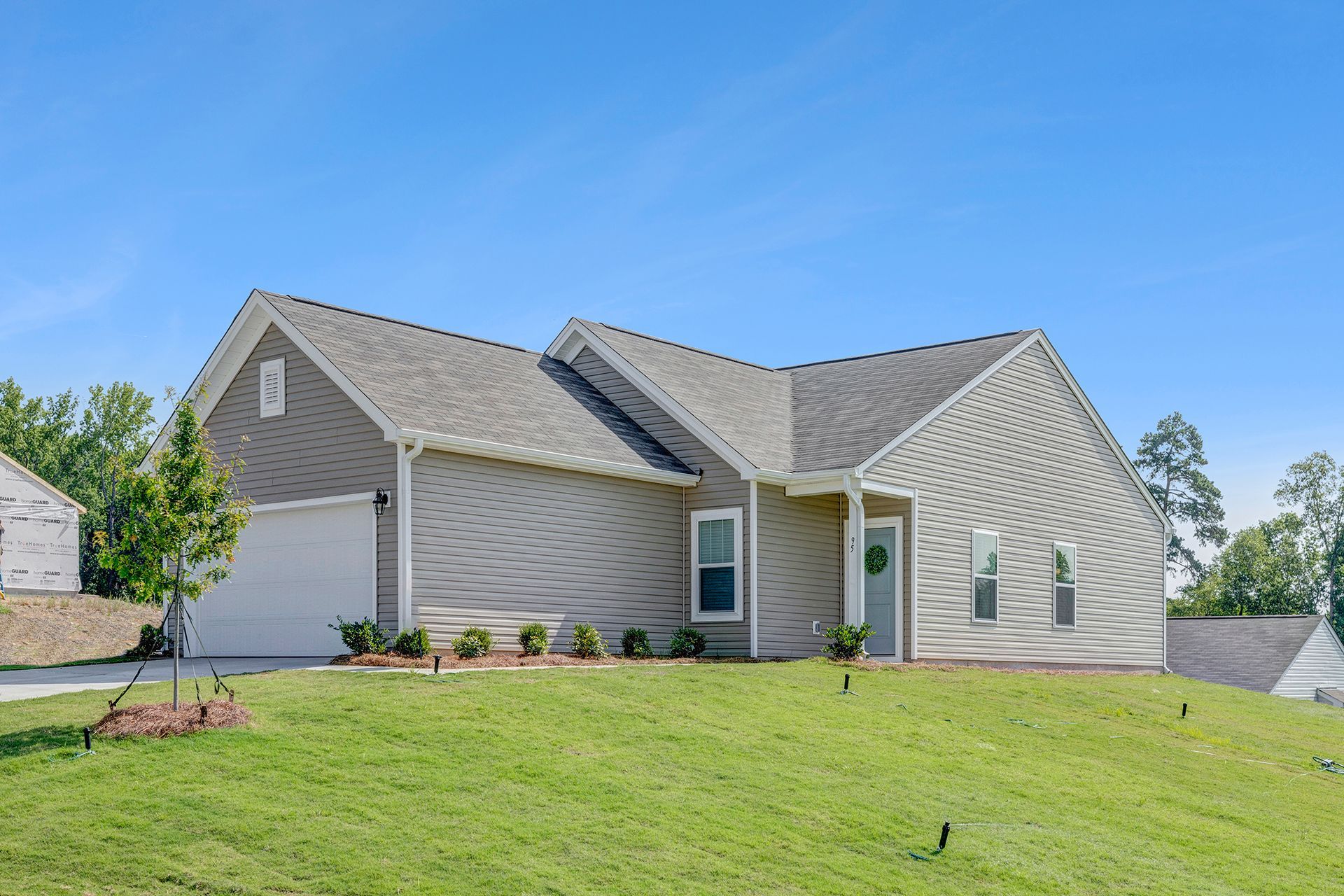A house with a large lawn in front of it.