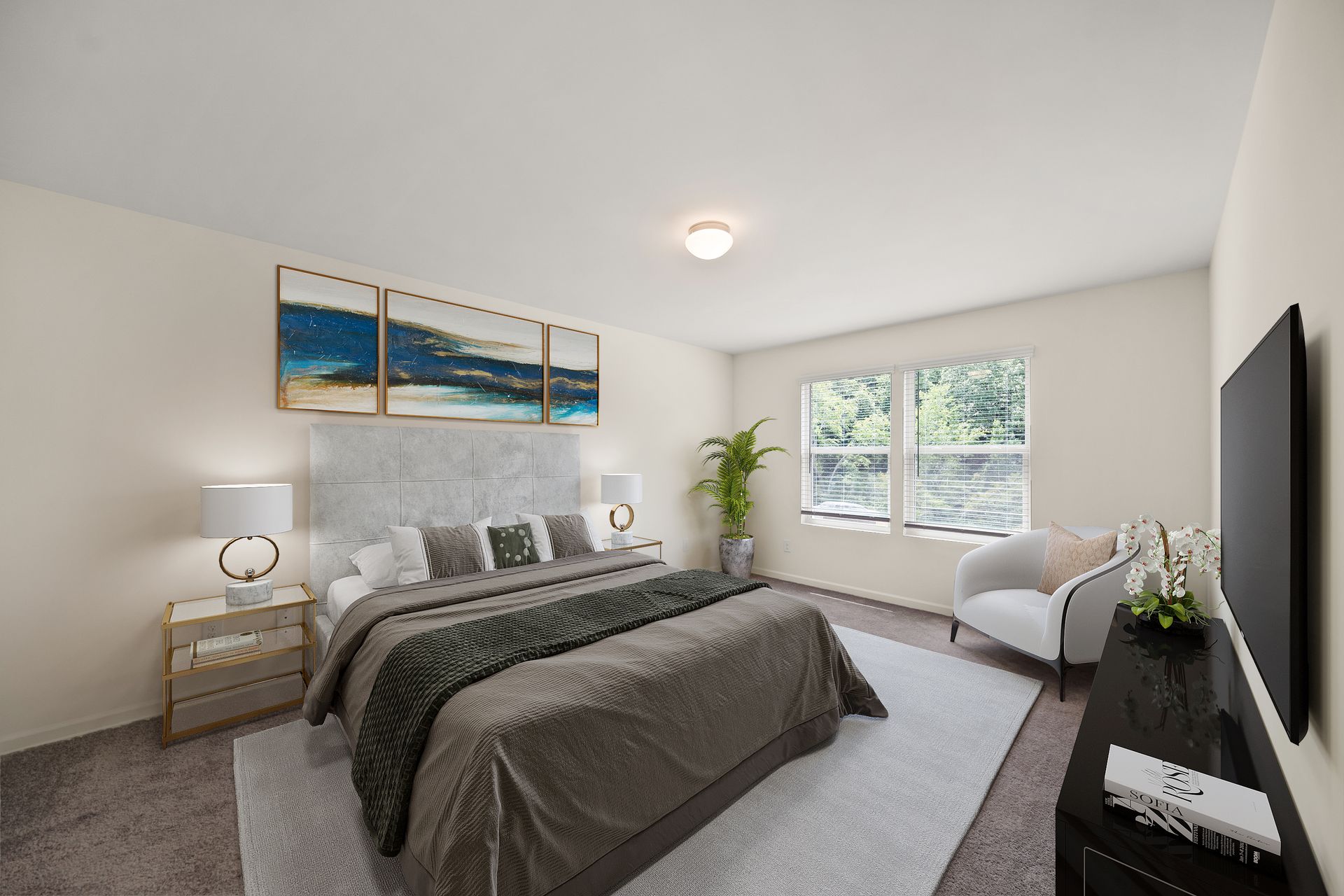 A bedroom with a large bed and a flat screen tv.
