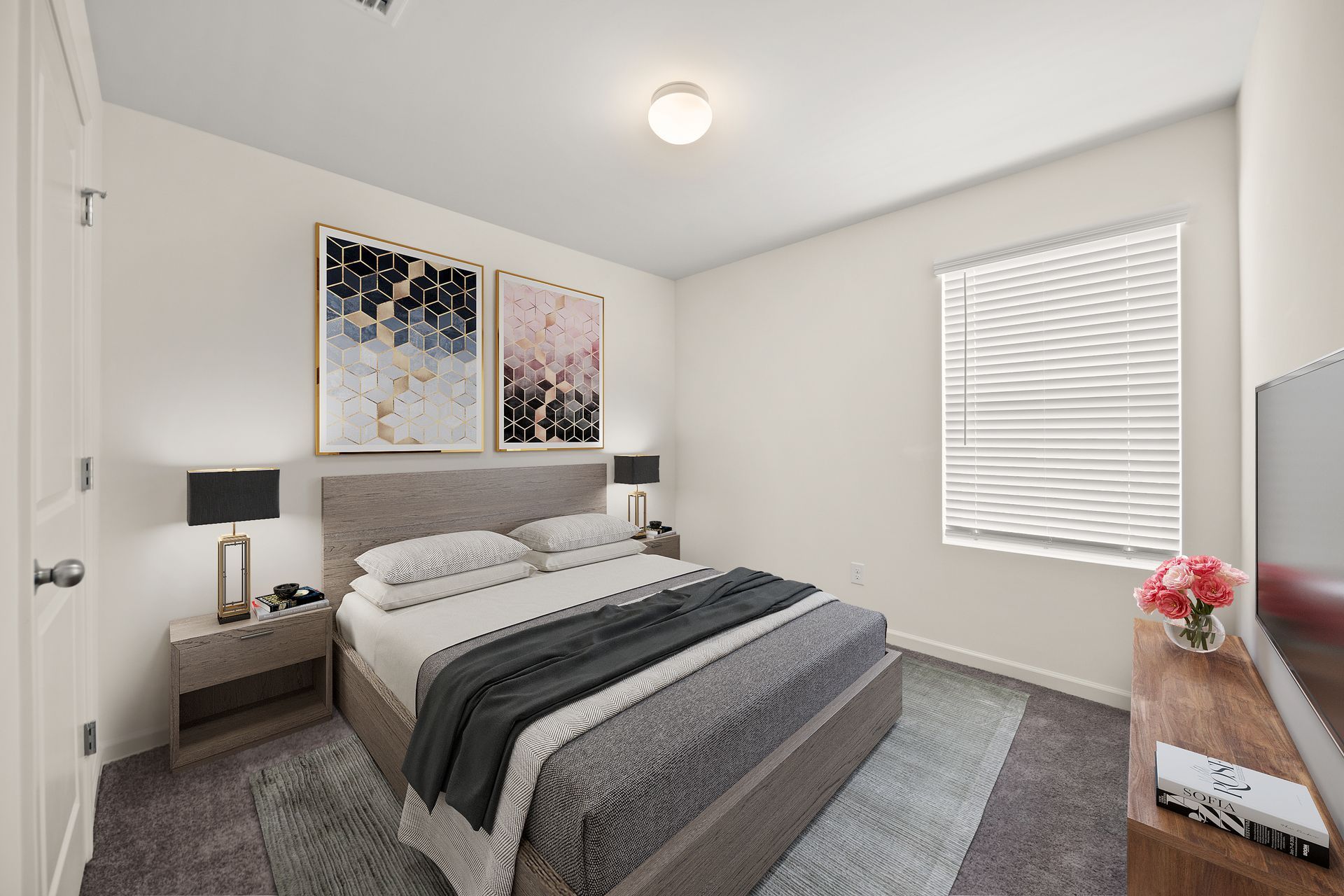 A bedroom with a large bed and a television