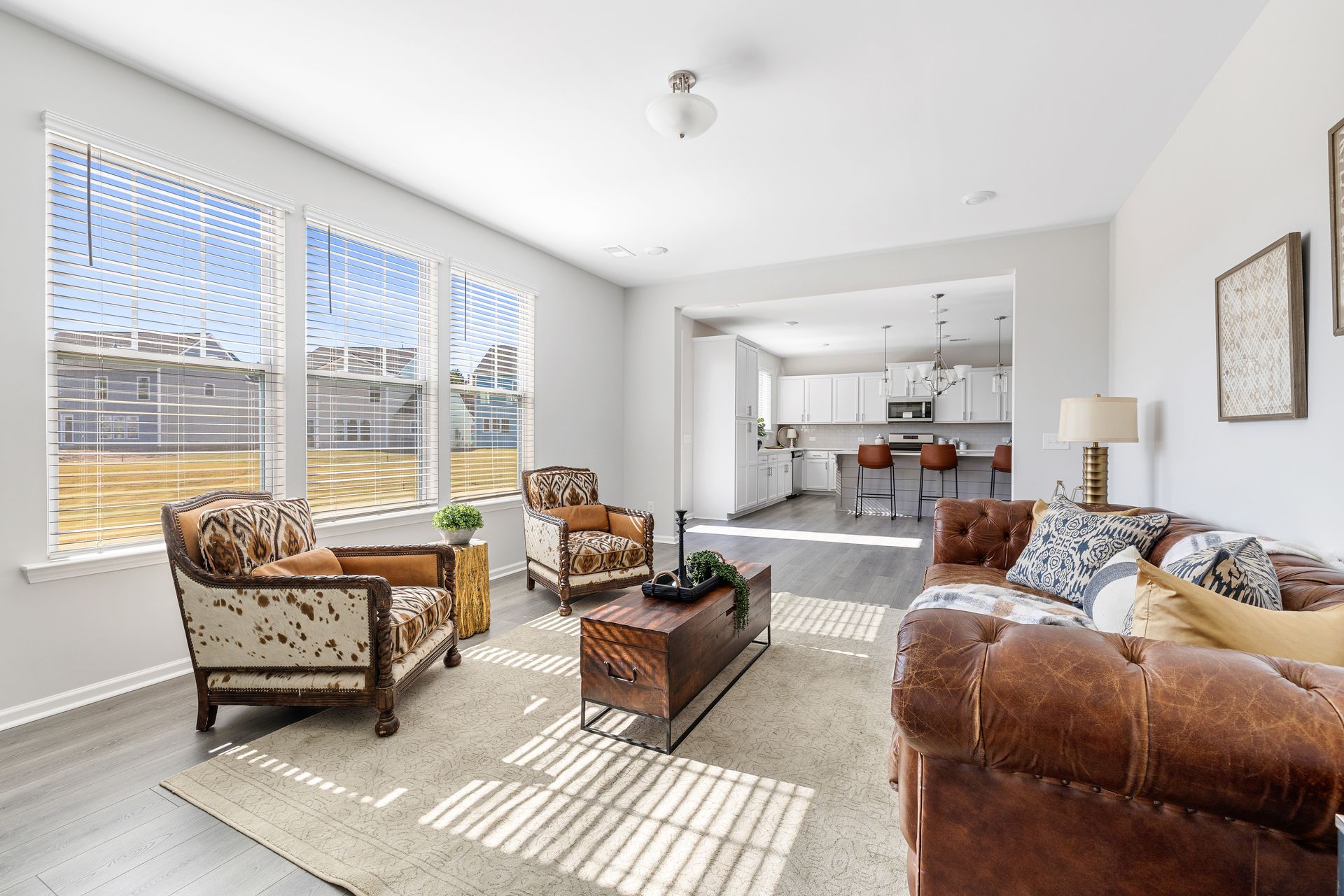 A living room with a couch , chairs , and a coffee table.