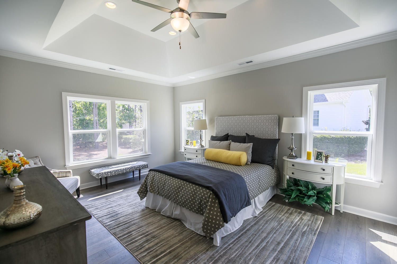 A bedroom with a bed and a ceiling fan.