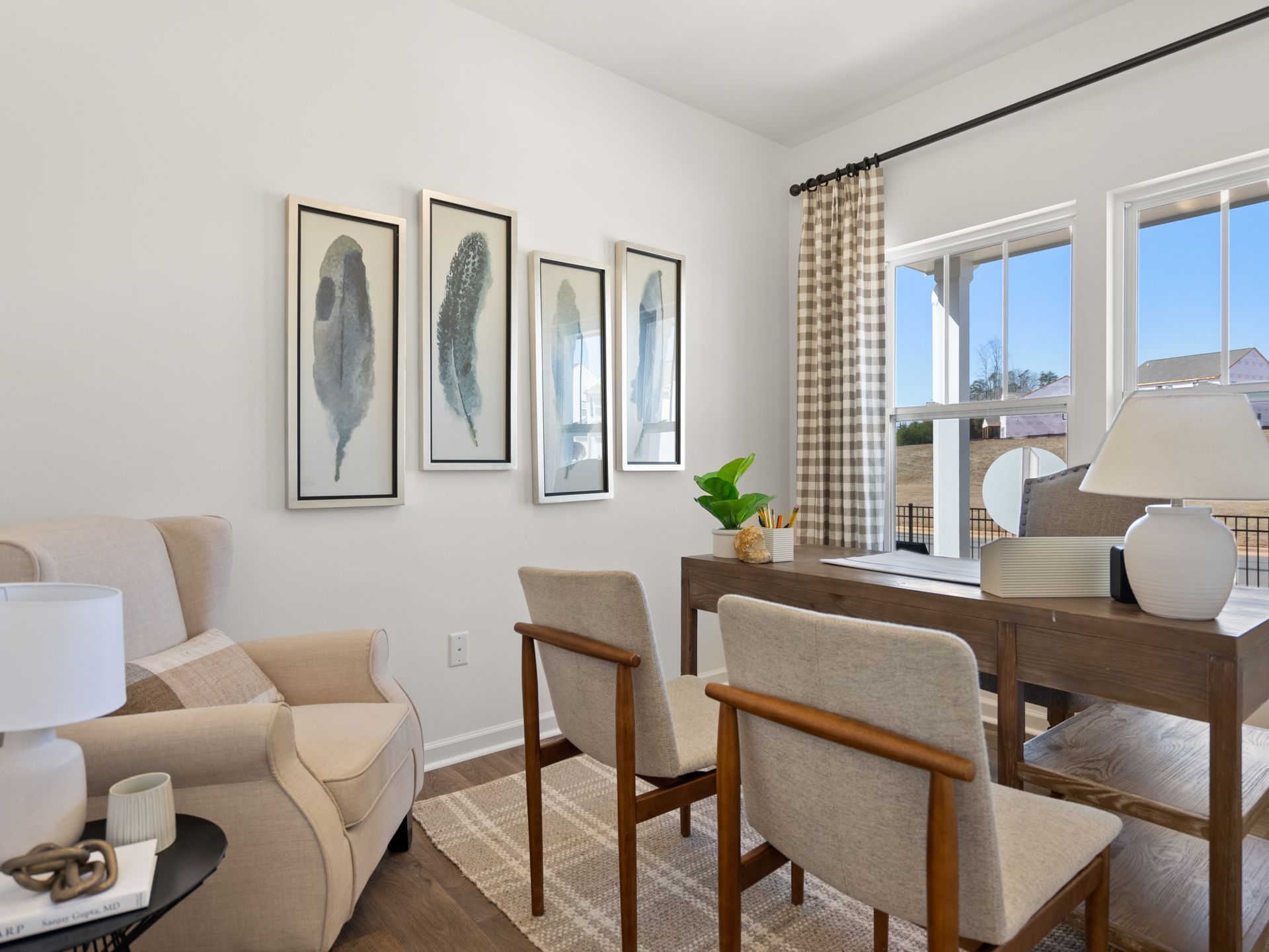 A home office with a desk , chairs and a chair.