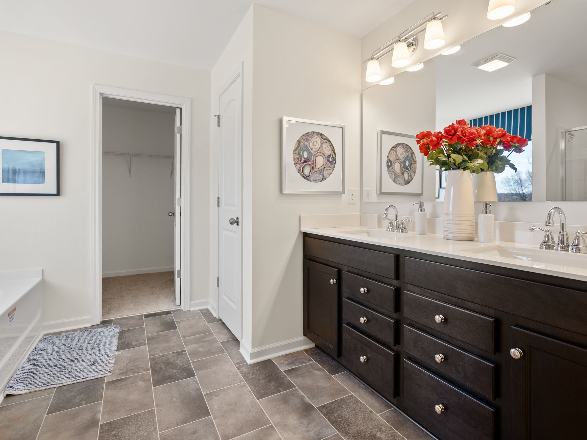 A bathroom with two sinks and a large mirror.