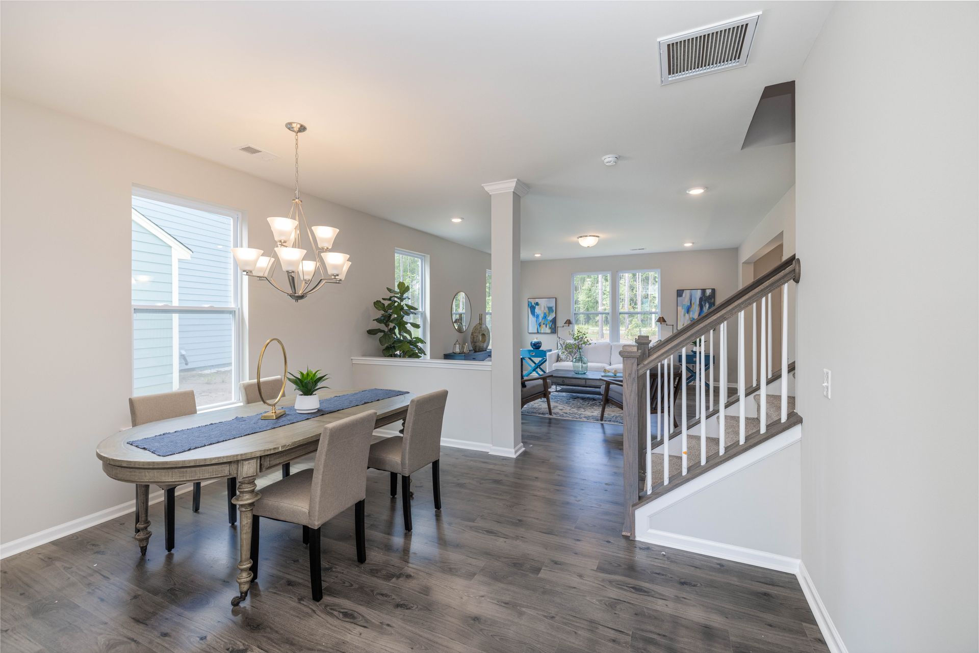 A dining room with a table and chairs and a chandelier.