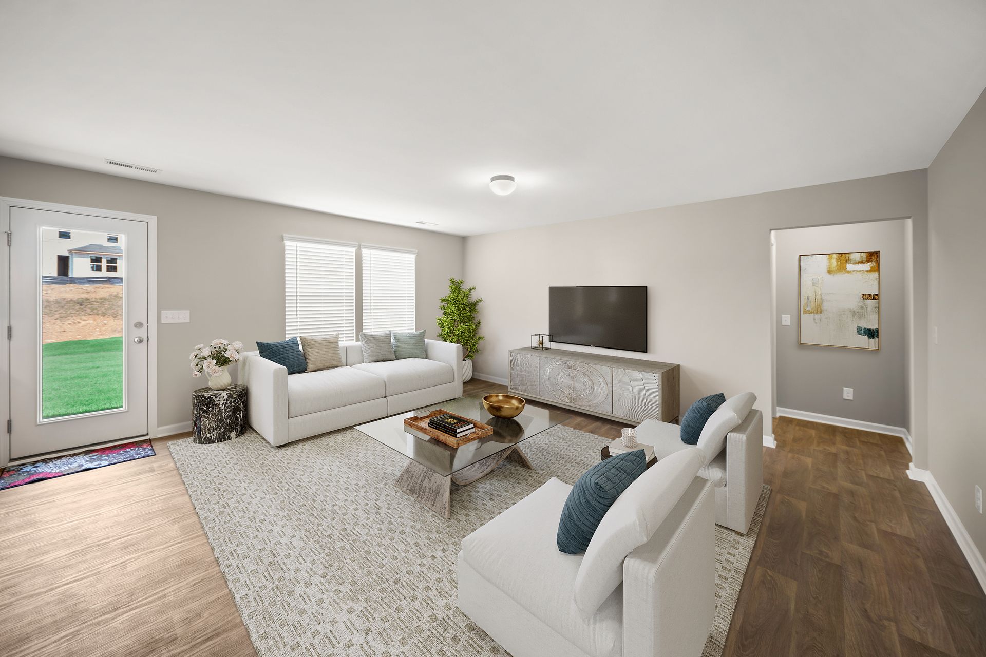 A living room with a couch , chairs , coffee table and television.